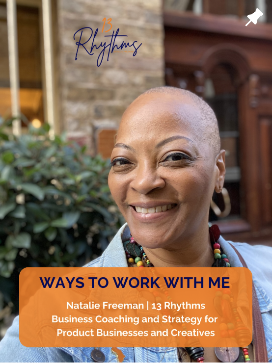 A smiling woman with a shaved head outdoors with greenery and brick building background, wearing colorful beaded jewelry, promoting a business coaching service.