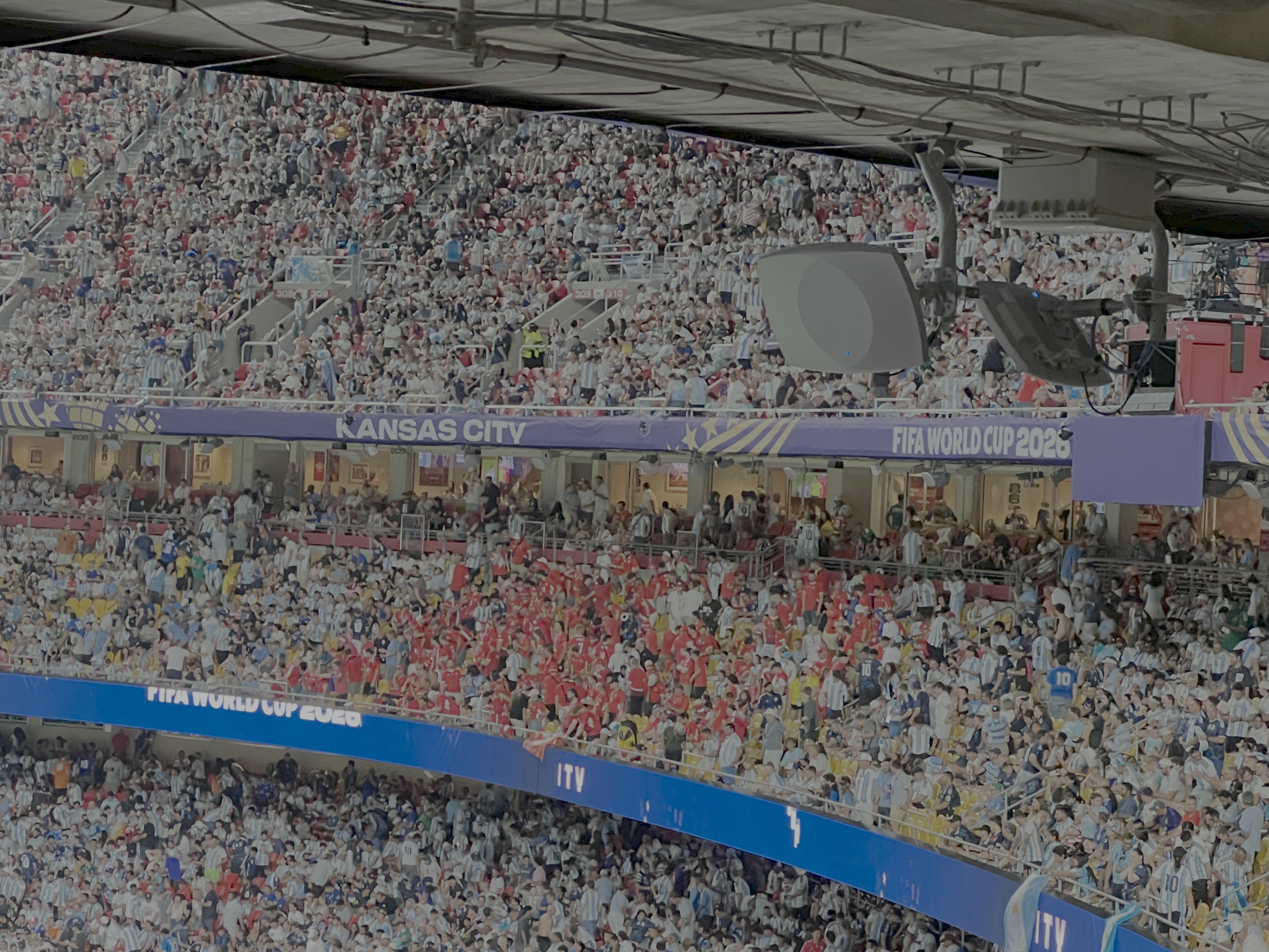 Packed stadium with a large sign for Kansas City FIFA World Cup 2026