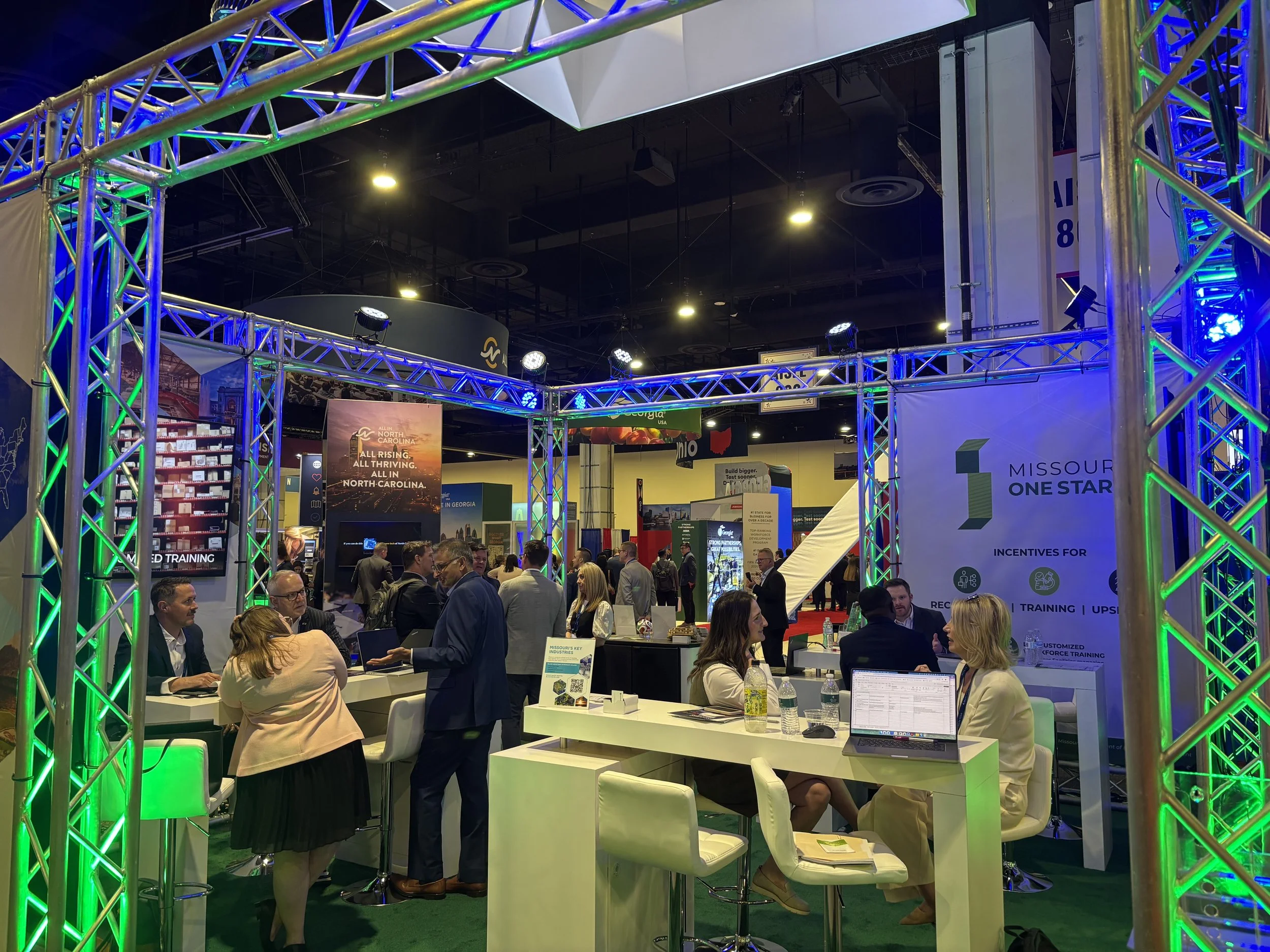 Trade show booth with many people in conversation