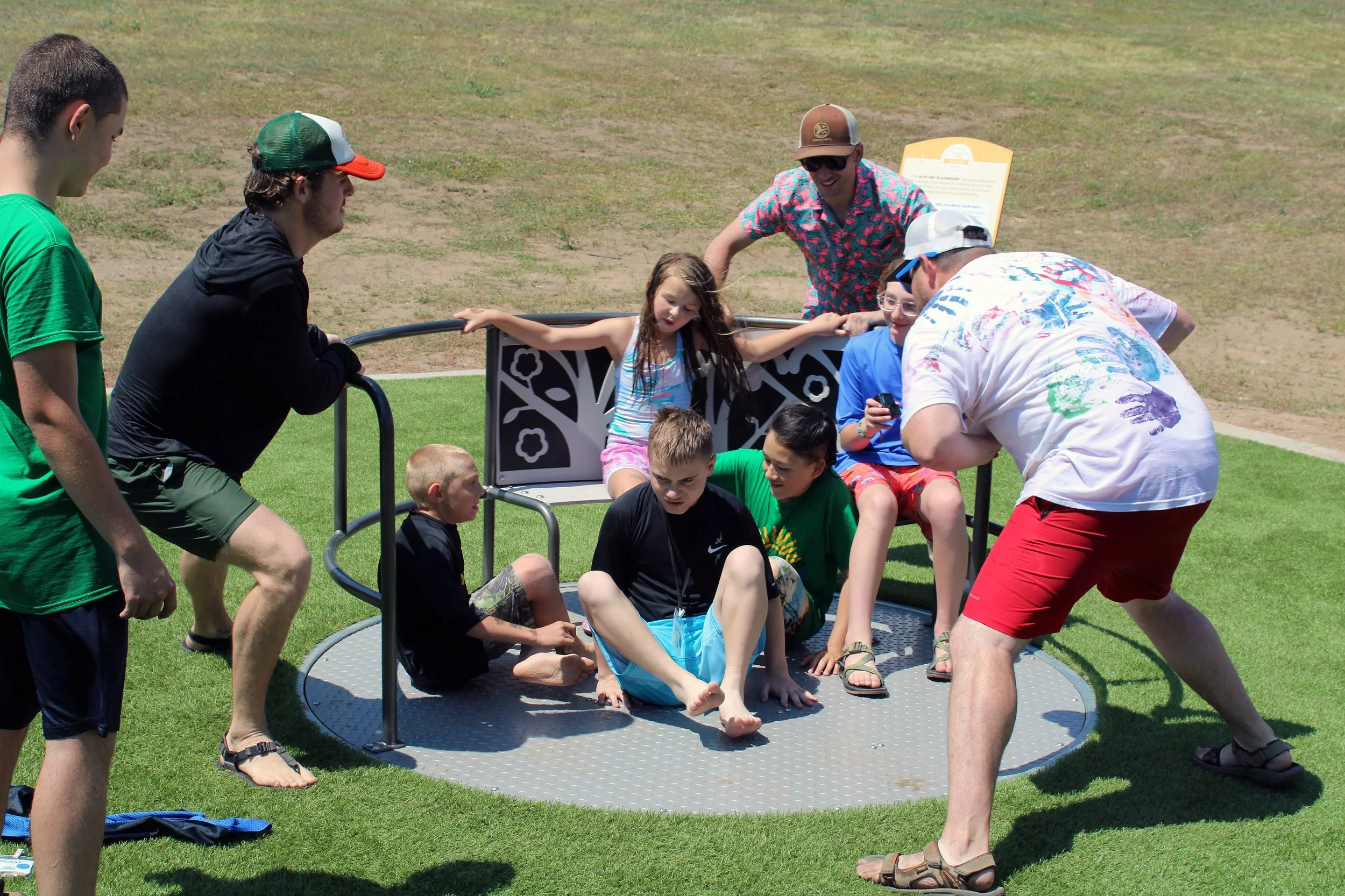 Campers and Volunteers playing on in outdoor playground