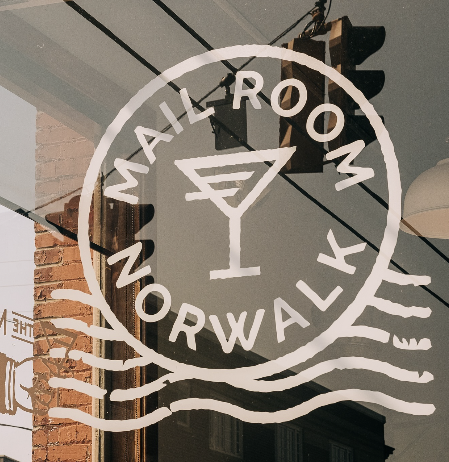 A window decal displays the words 'WAIL ROOM' and 'BACKWARDS' with a martini glass icon.