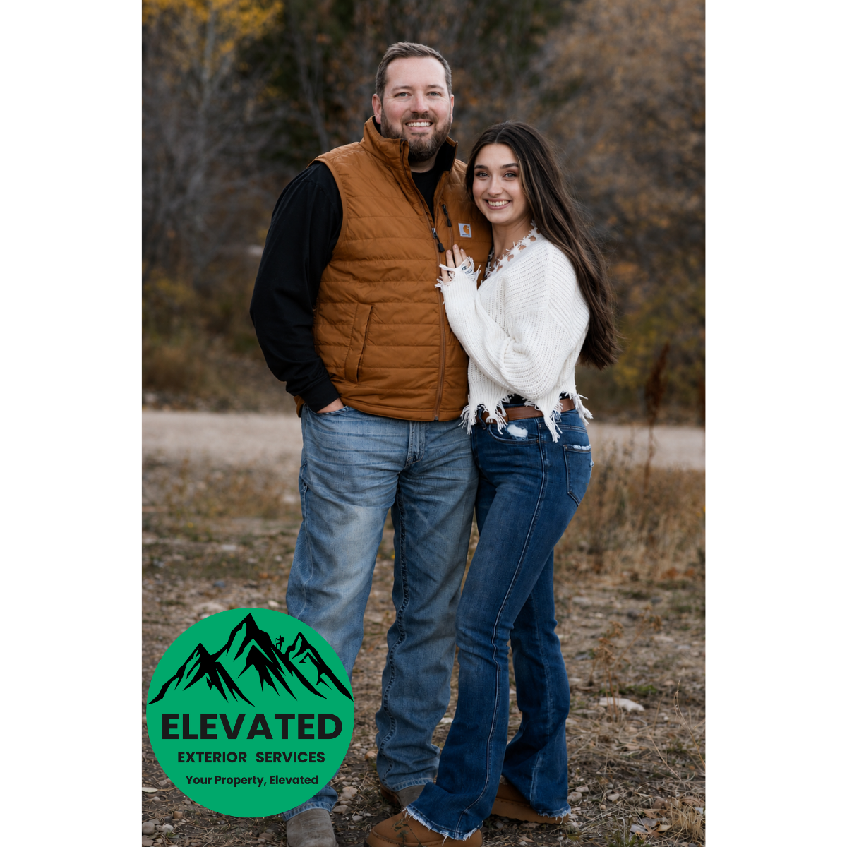 A man and woman standing outdoors in fall clothing, smiling, with trees and a dirt path in the background. The woman is wearing a white sweater and blue jeans, and the man is wearing a brown vest over a black shirt and blue jeans. There is a green circular logo with mountains, the text "ELEVATED EXTERIOR SERVICES," and the slogan "Your Property, Elevated" in the bottom left corner.