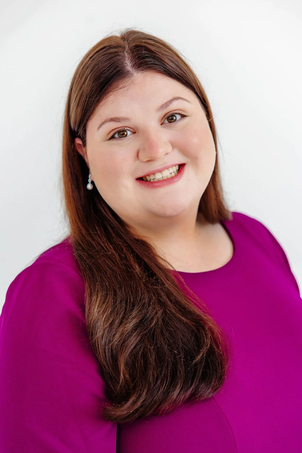 Jami Diamond, paralegal, smiling wearing a purple top and pearl earrings, smiling at the camera against a plain white background.