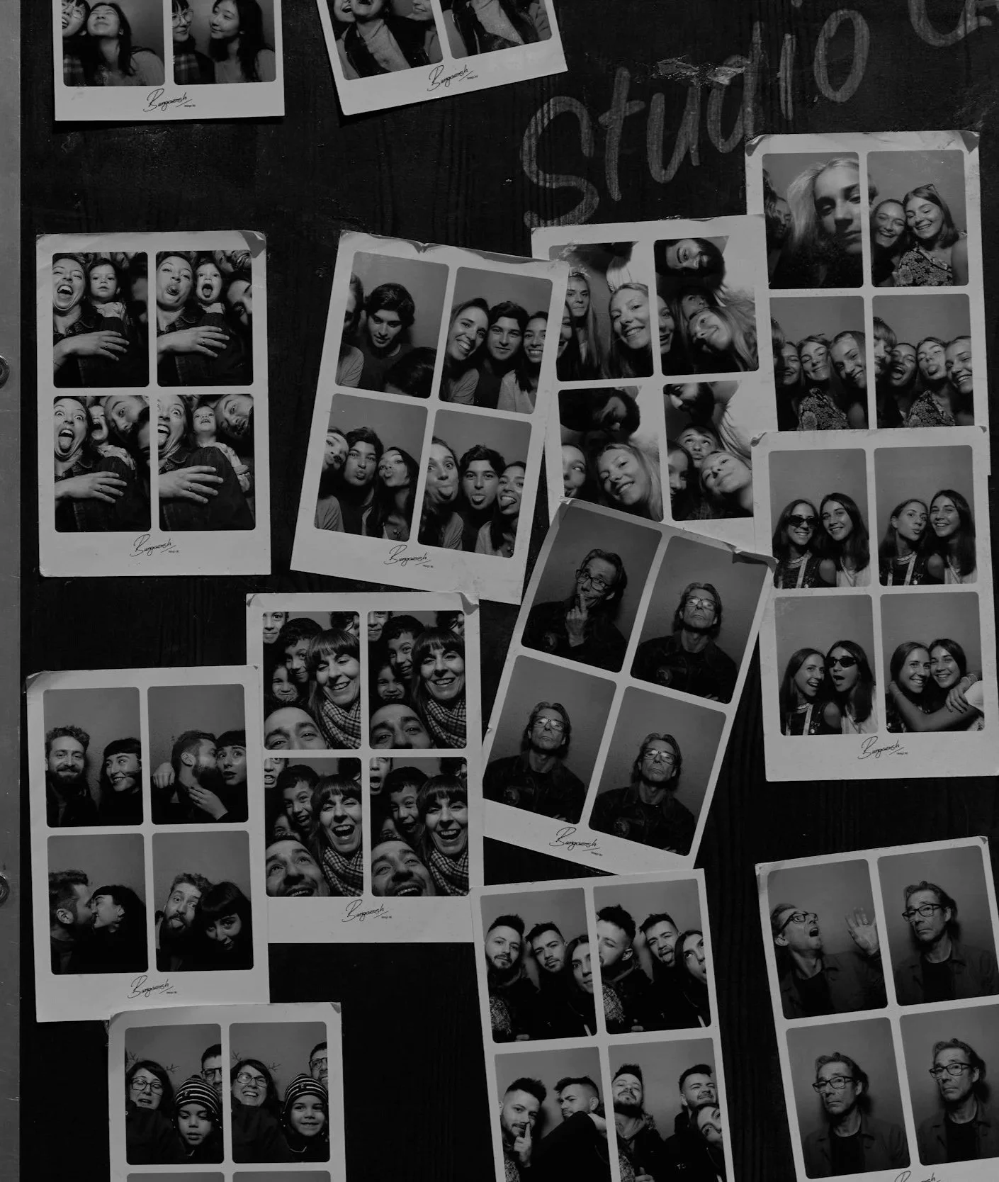 Multiple black and white photo booth strips showing various groups of people smiling, making funny faces, and posing together.