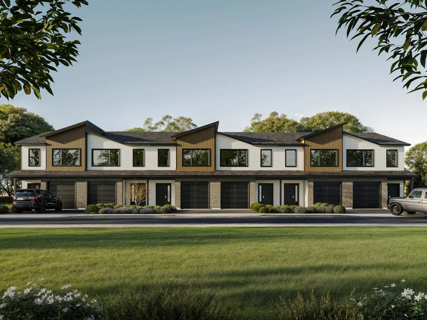A modern multi-family residential building with eight units, featuring black garage doors, large windows, and a mix of white and brown exterior panels, situated along a tree-lined street with parked cars and landscaped front yard.