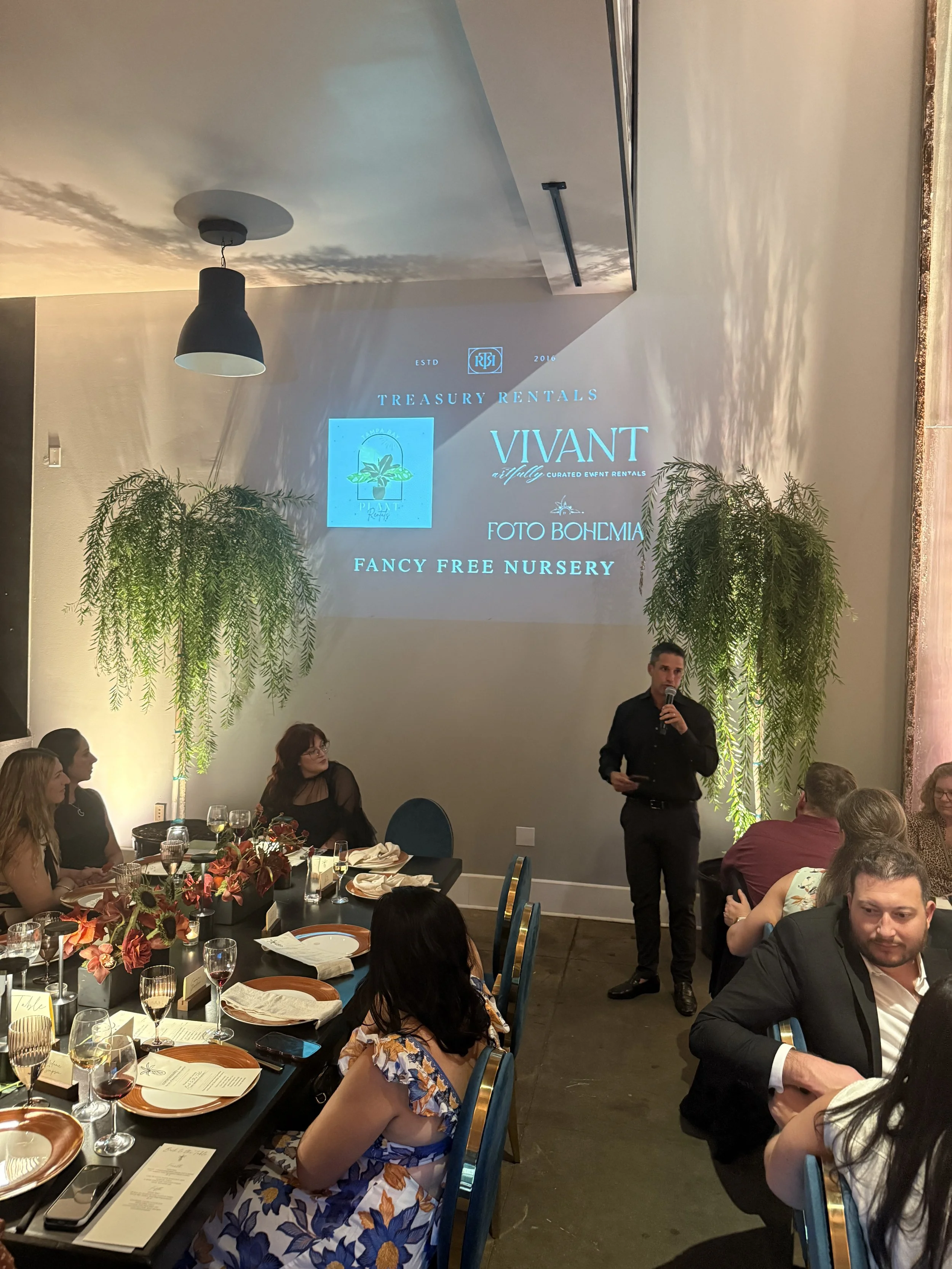 Corporate event presentation with projection, stage lighting and a live audience in Tampa Bay.