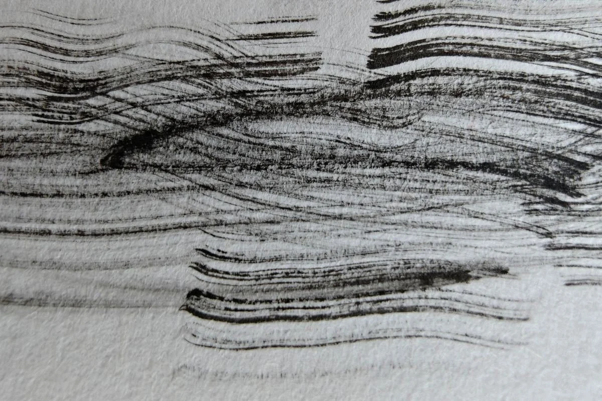 Close-up of a wood surface with dark, wavy grain patterns.