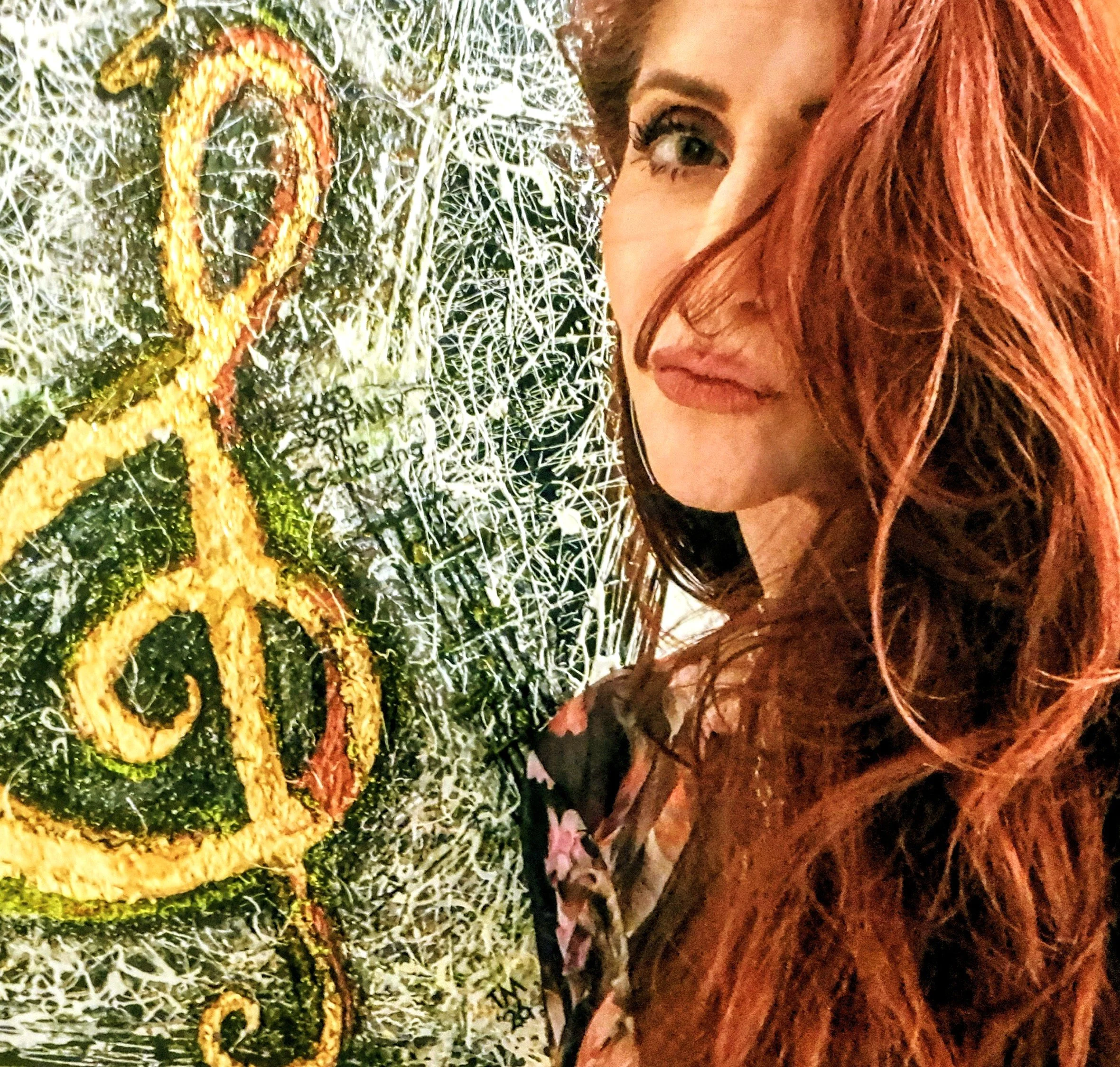 Tracy Moore poses with her painting Soul Alley.  A contemporary piece with texture and body that would be perfect for a music room.