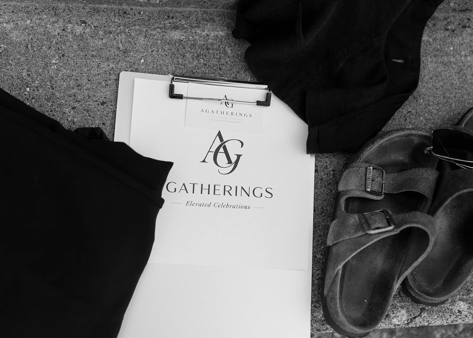 Photo of a gathering event setup with a clipboard, greeting card, and crutch on a concrete surface.