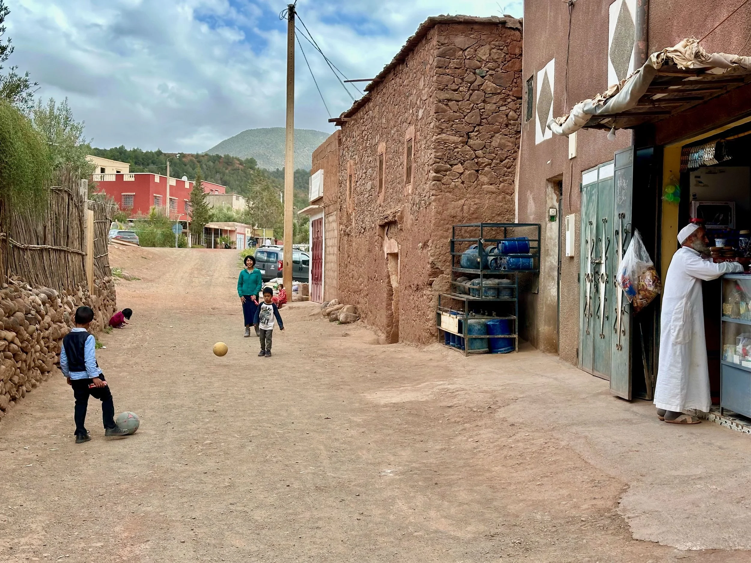 Ethan playing soccer in the village