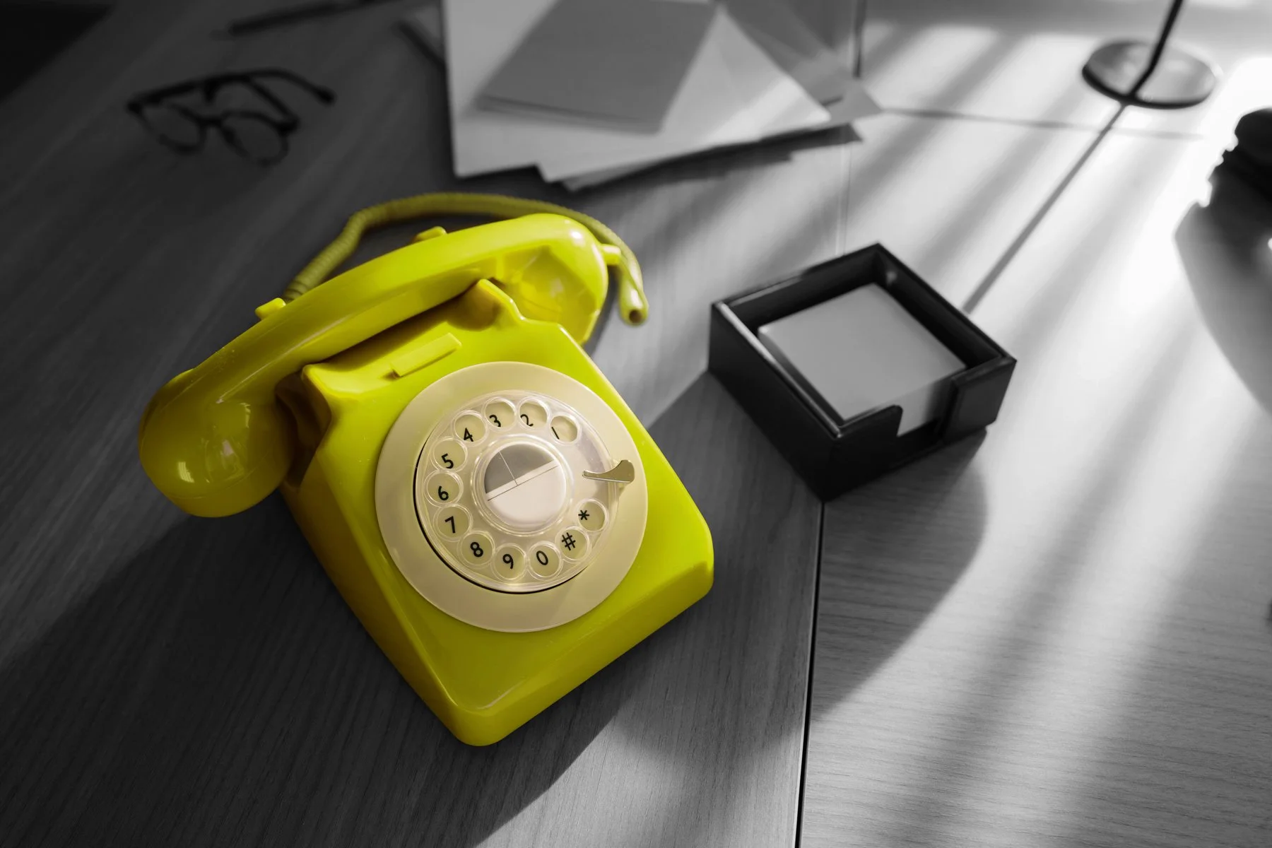 The Bias Adjuster communication concept featuring a vintage yellow rotary telephone