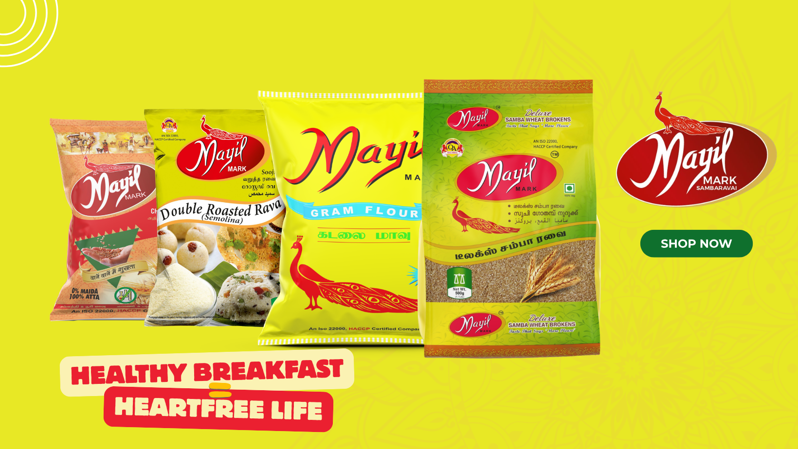 Packages of Mayil brand Indian food ingredients, including rice, gram flour, and semolina, displayed against a yellow background with a green "Shop Now" button and the slogan "Healthy Breakfast = Heartfree Life".