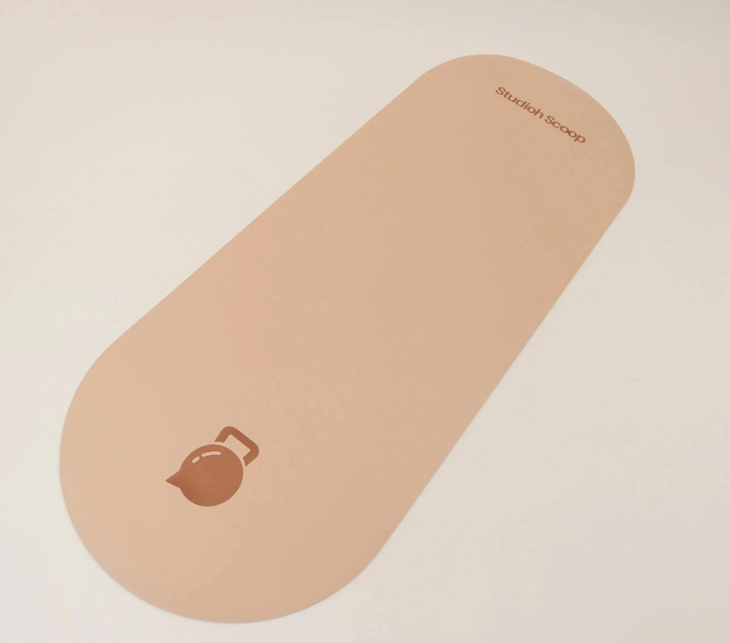 A beige keyboard key with the words 'Studion Scoop' printed on it, and an icon of a spoon at the bottom corner.