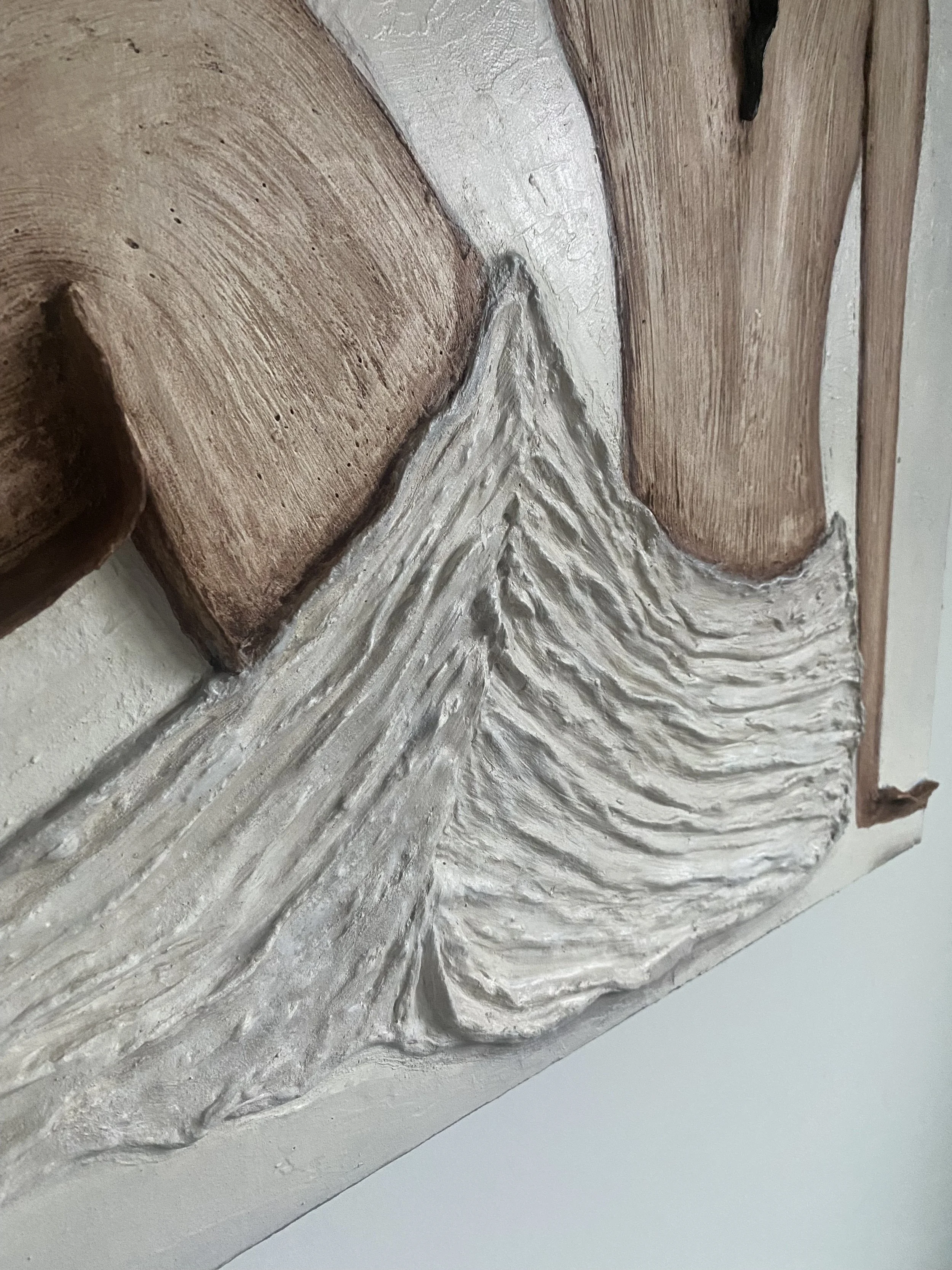 Close-up of ornate carved wooden architectural trim with silver-painted leaf detail