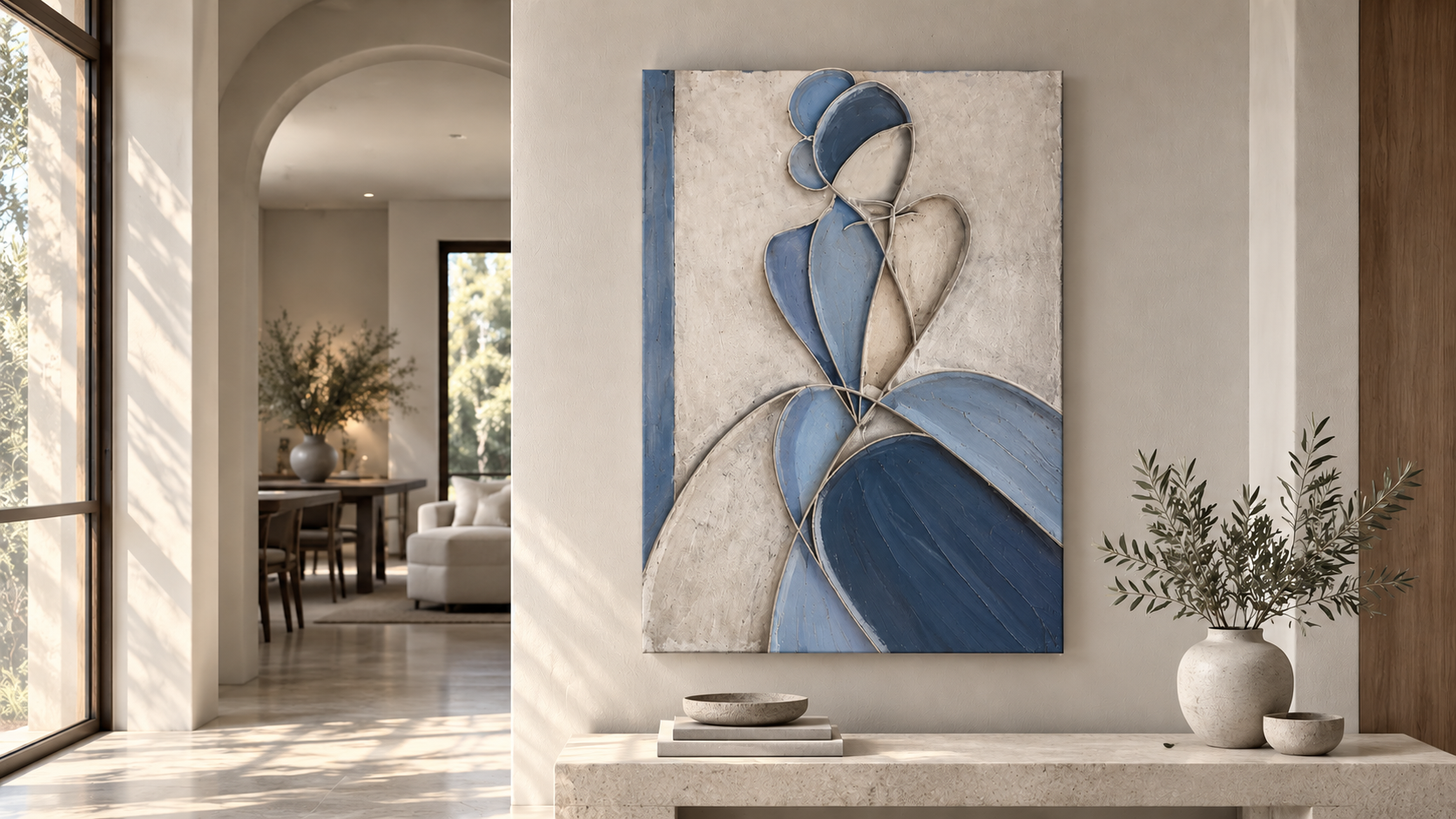 Modern home interior with blue abstract floral wall art, white console table, ceramic vases, and olive branches