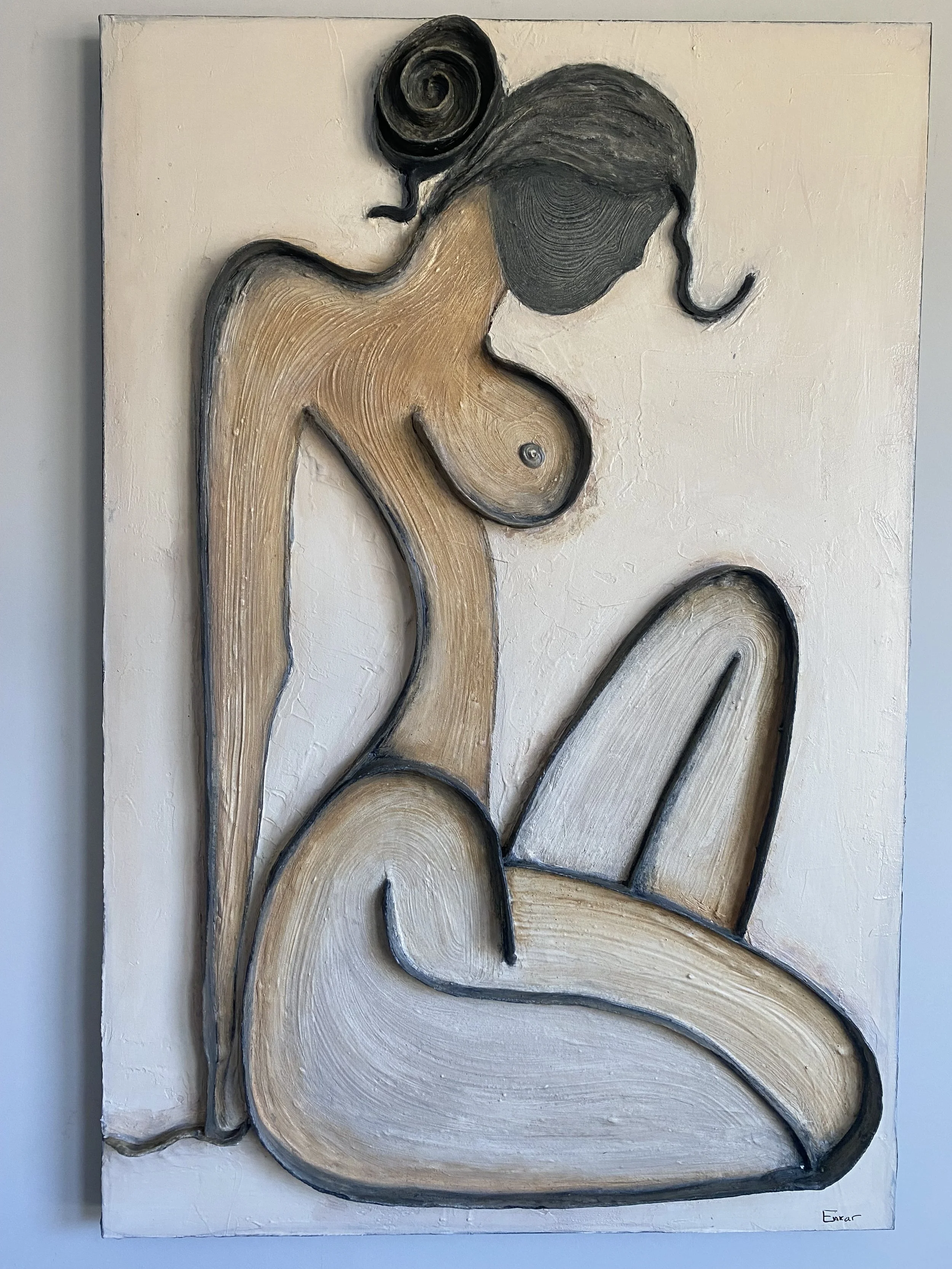 Abstract textured wall sculpture of interlocking wood-grain shapes in tan, black, white, and gray on a rectangular canvas