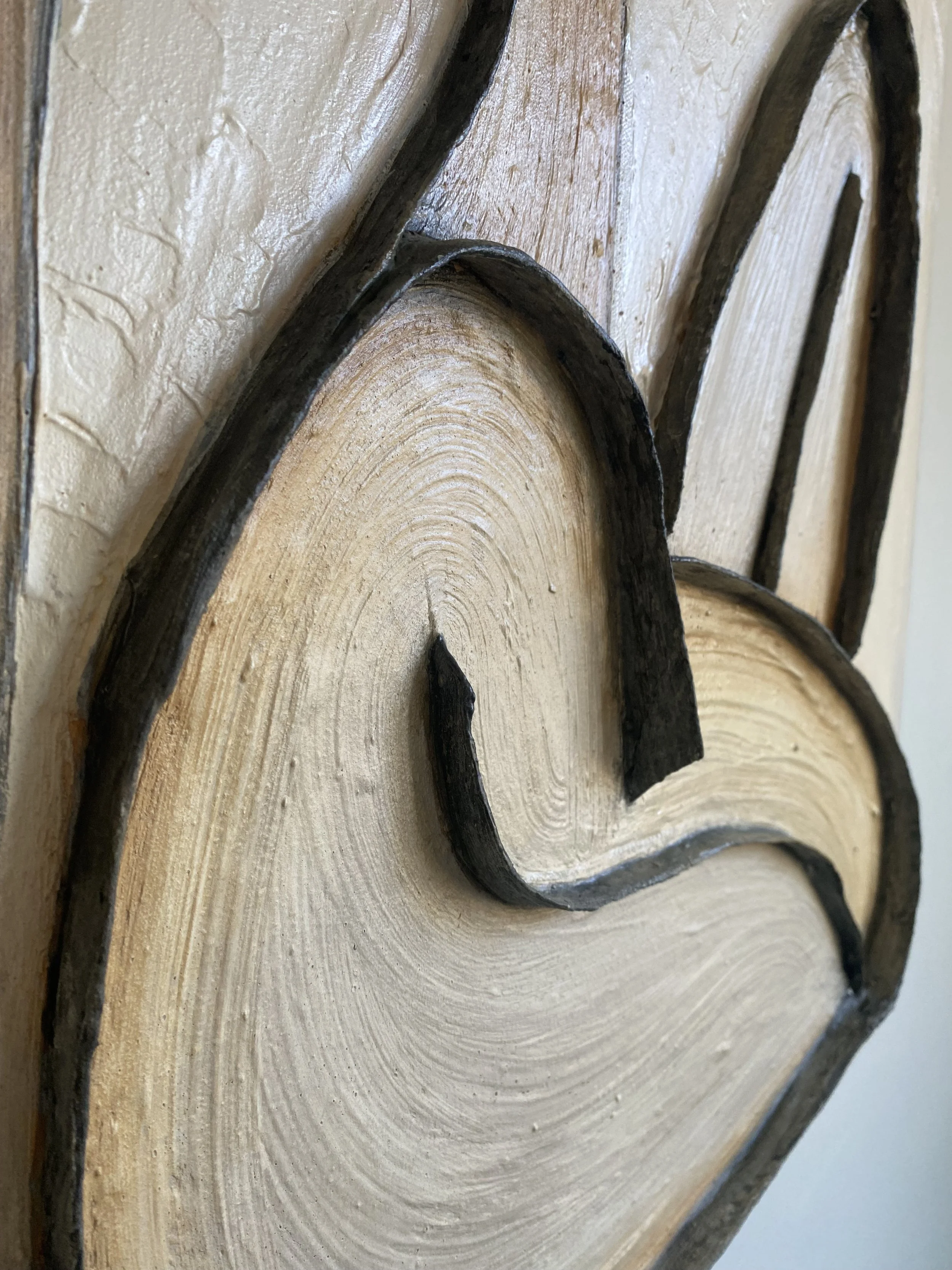 Close-up of overlapping curved wooden pieces with visible growth rings and dark bark edges