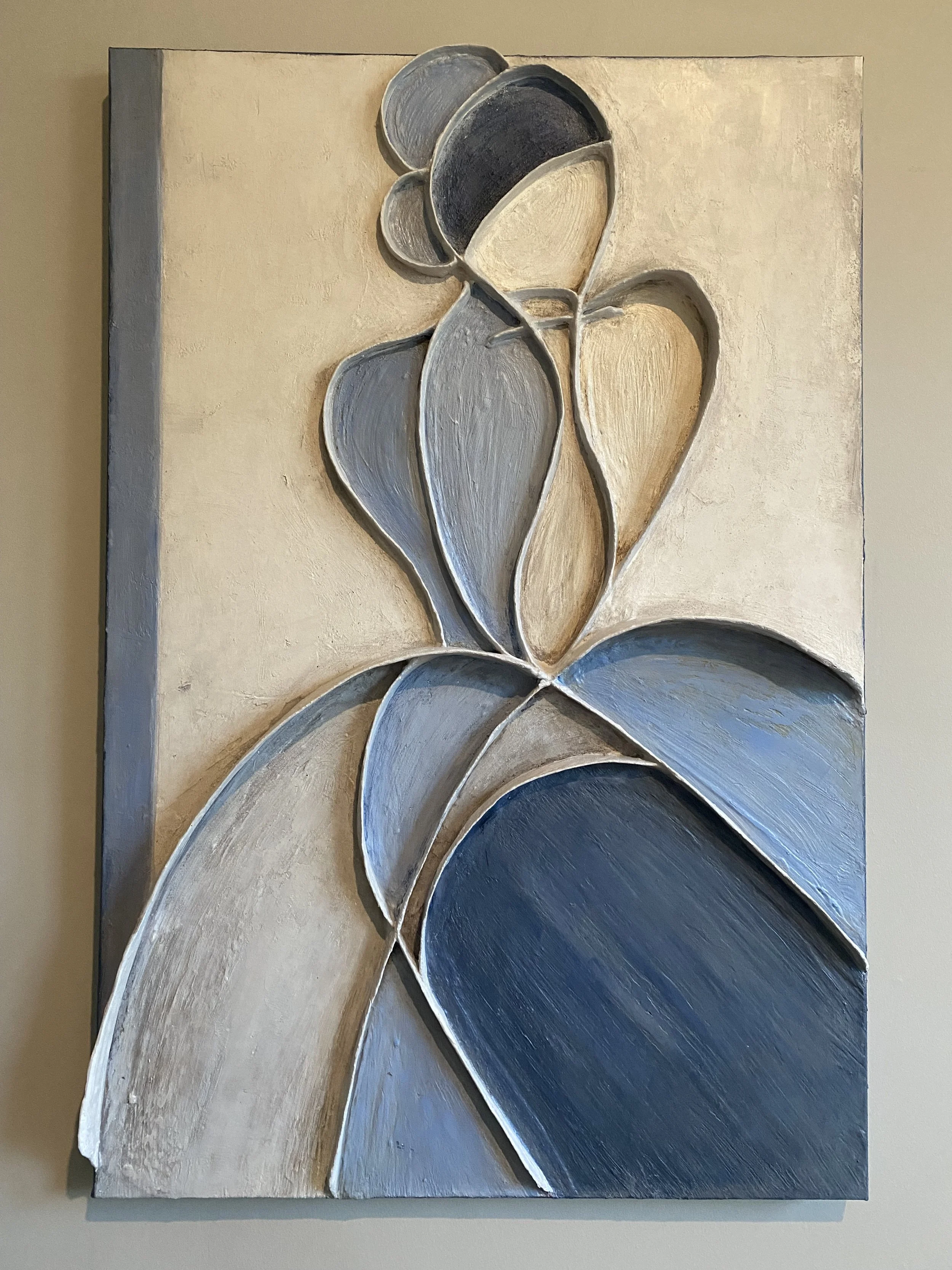 Close-up of a textured abstract floral wall sculpture with layered blue, gray, and cream petals.