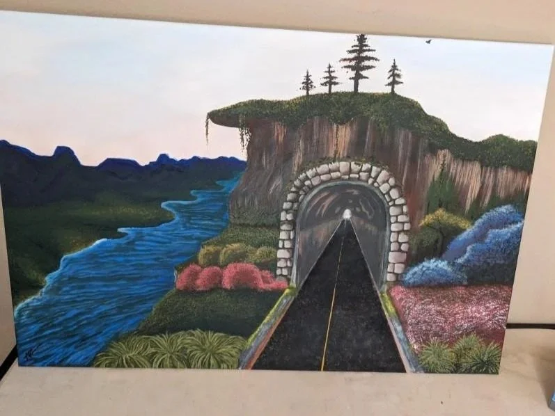 A painted landscape with a train tunnel built into a hill. The scene includes a river on the left, mountains in the background, colorful shrubs, and trees on a grassy top of the hill.