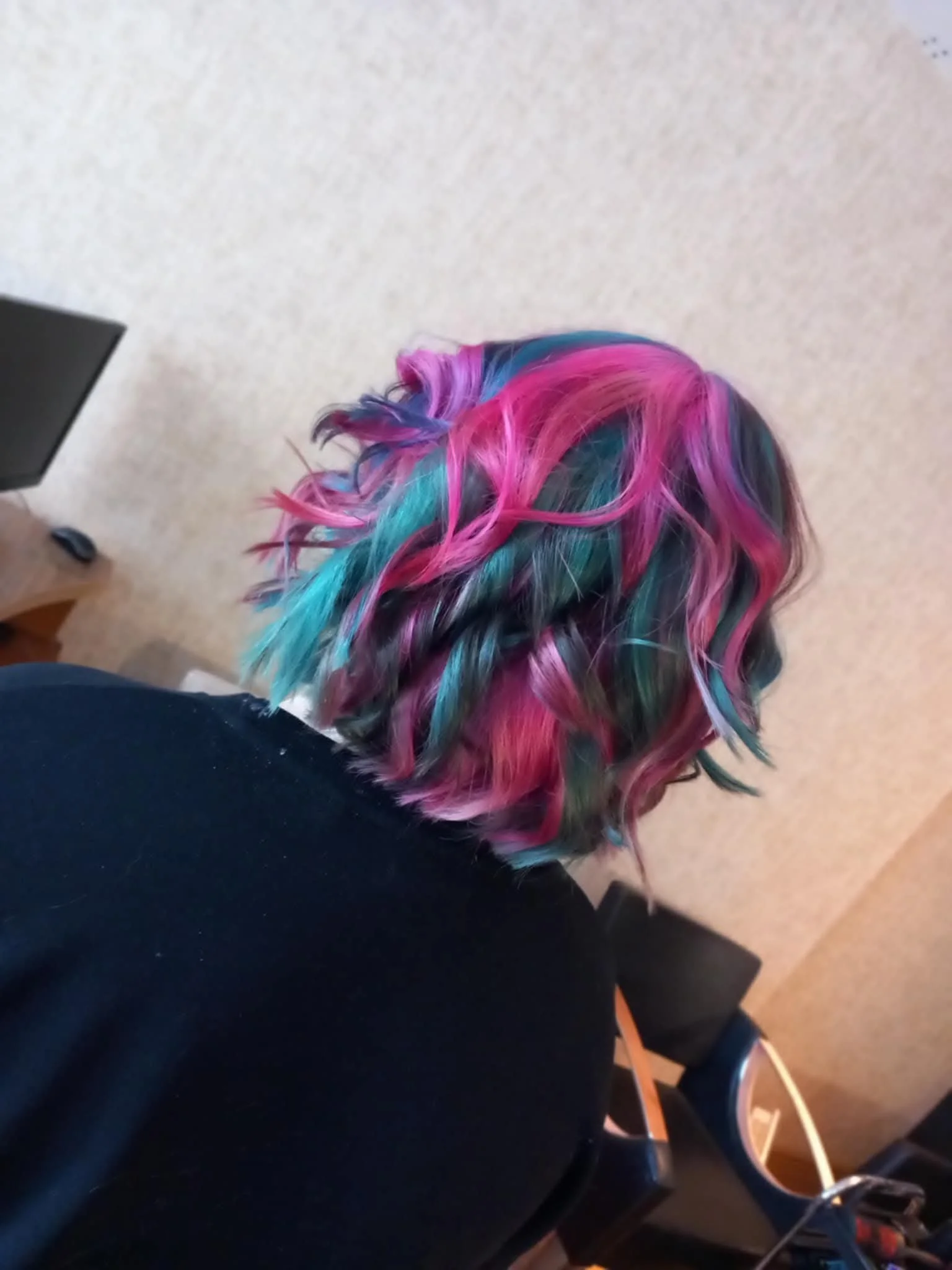 Colorful, multi-colored hair with pink, blue, purple, and teal hues.