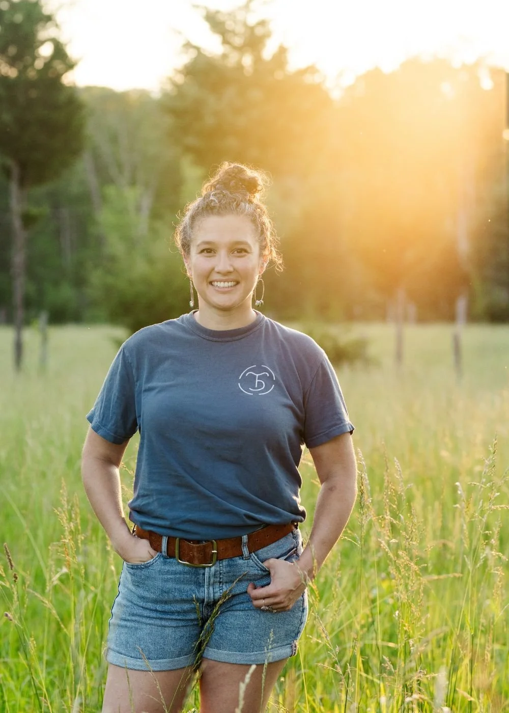 victoria mexcur standing in a field during golden hour