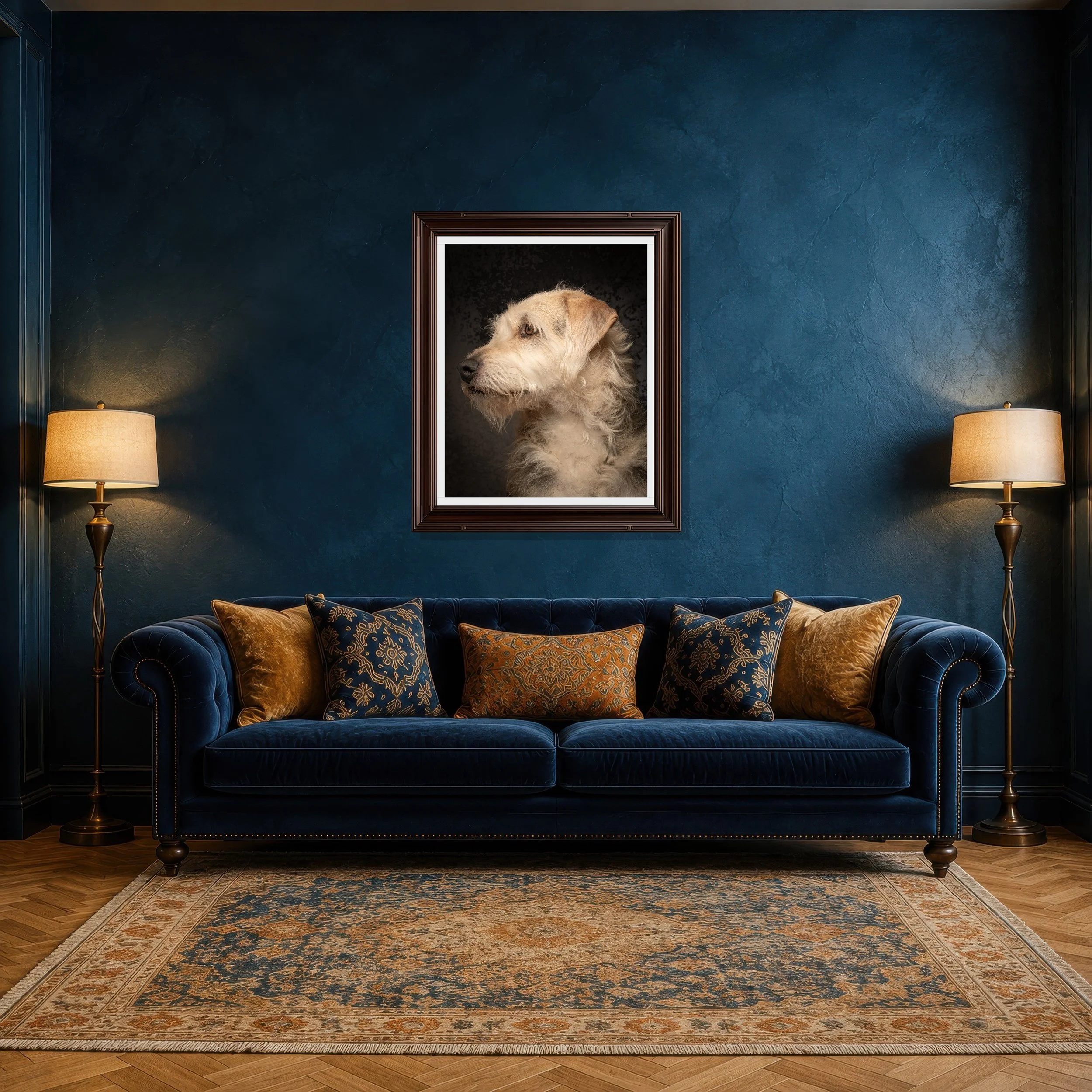 Living room with dark blue textured walls, a velvet blue sofa with gold and blue patterned pillows, two matching floor lamps, and a framed picture of a dog on the wall, placed over an ornate area rug with a floral pattern.
