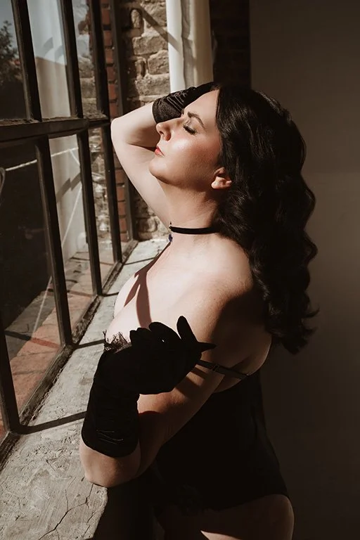 woman in black gloves, black choker, and black lingerie with Hollywood style waves