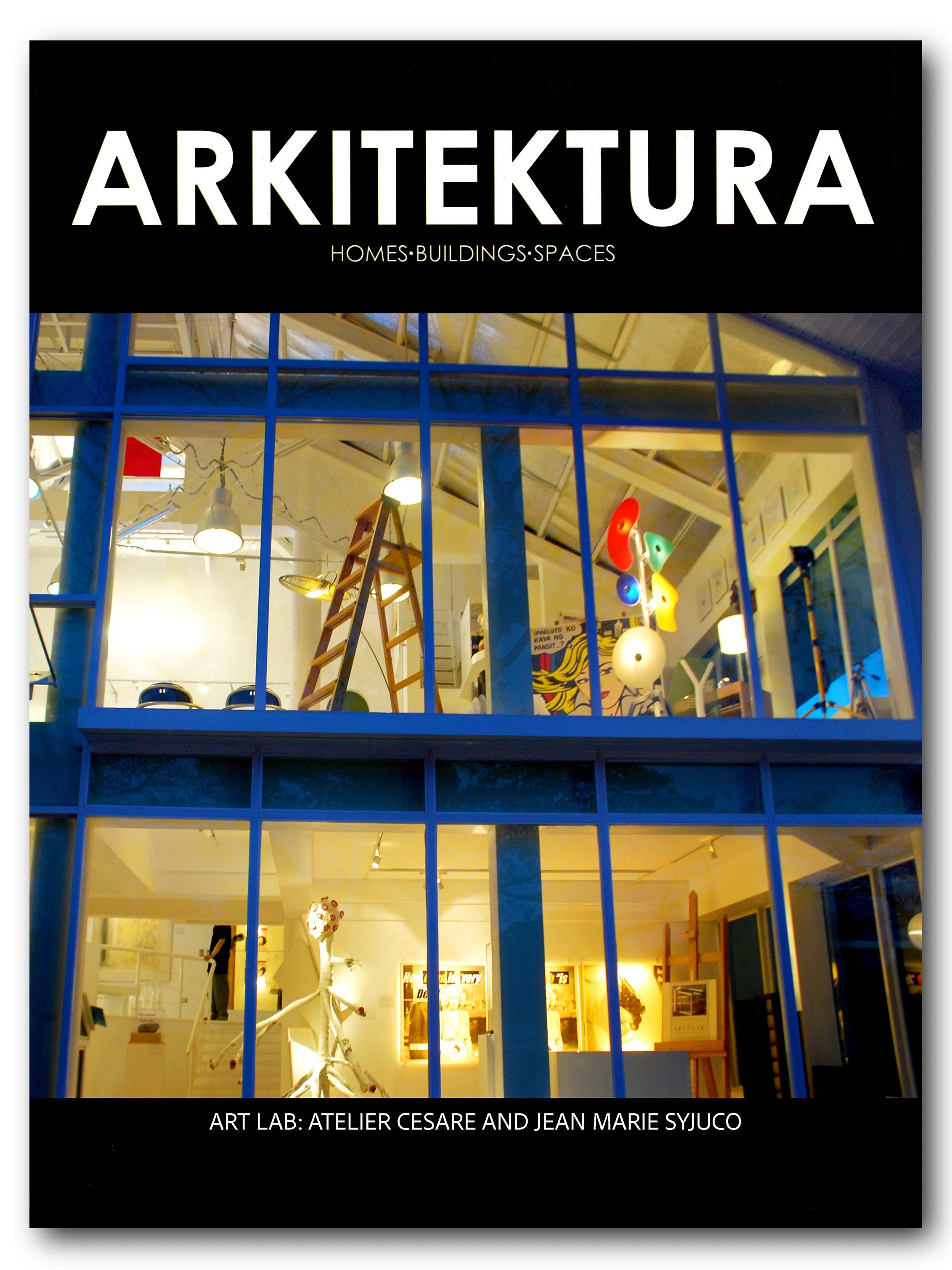 The image shows the front of an art gallery named ART LAB: ATELIER CESARE AND JEAN MARIE SYJUCO, with large windows revealing an interior with lighting, art displays, sculptures, and a multicolored abstract light installation. Magazine cover