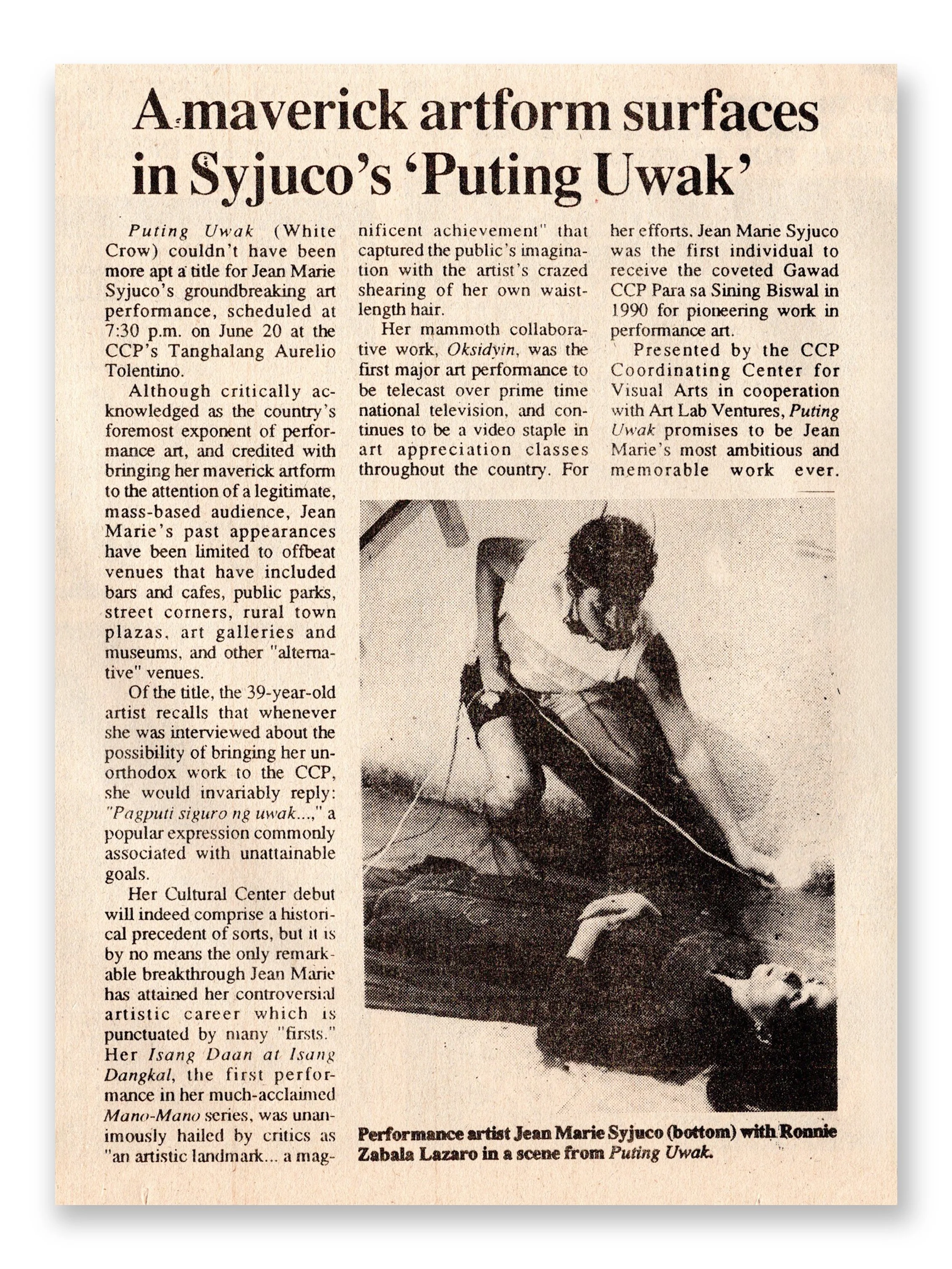 A newspaper article with a black-and-white photo of a woman in traditional attire, performing a dance with a bow and arrow. The headline discusses Jean Marie Syuco's art performance called 'Puting Uwak with actor Ronnie Lazaro Art Lab The Syjuco Mus