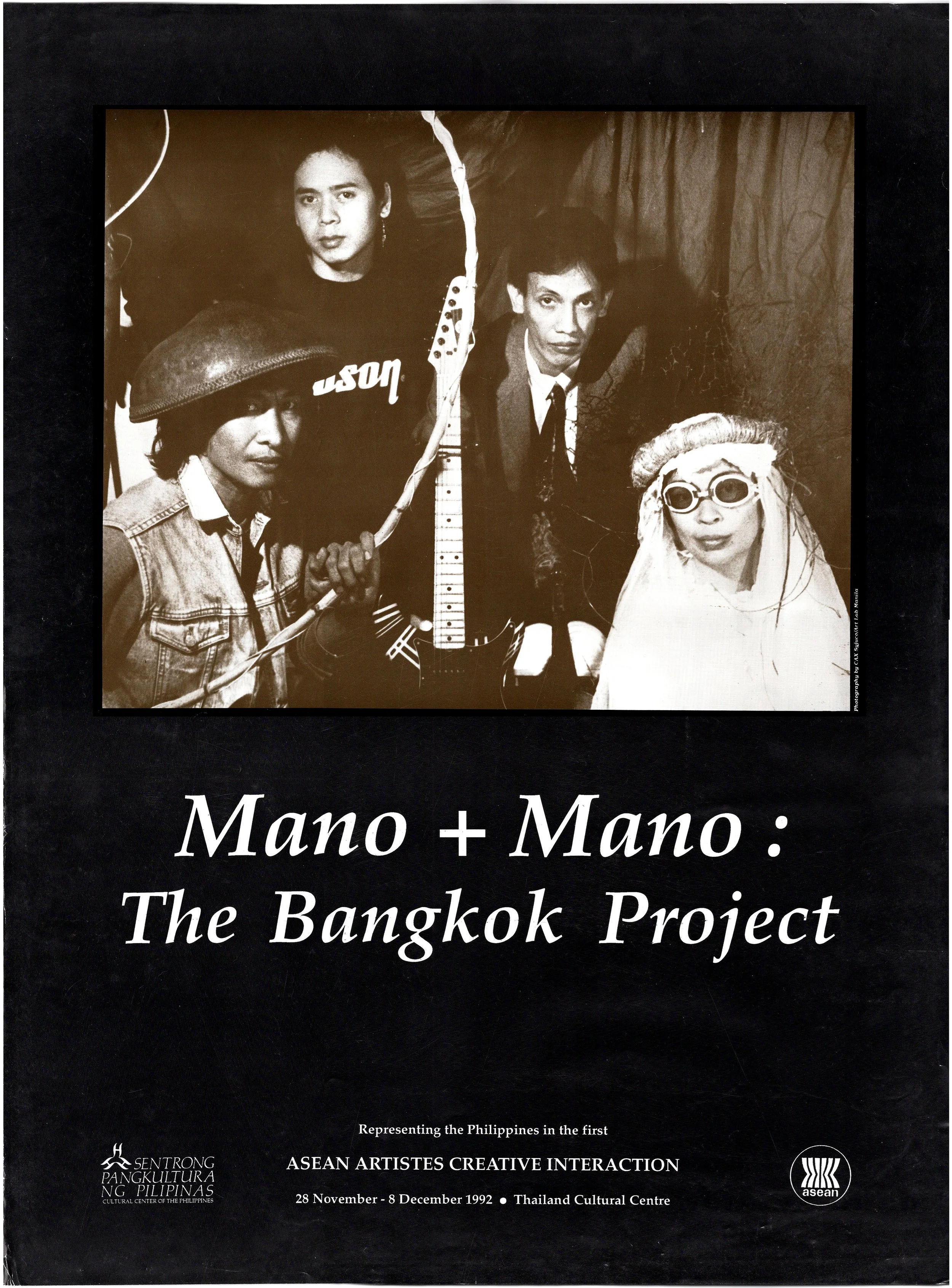 Cover of a book titled 'Mano + Mano: The Bangkok Project,' featuring a black and white photograph of four people, two men and two women, with one woman wearing sunglasses and a head covering, and a guitar in the center. The book is part of the ASEAN 