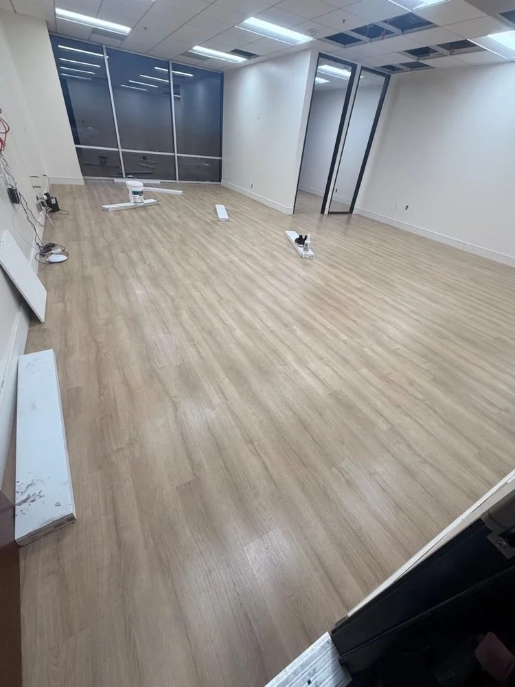 Commercial office tenant improvement featuring architectural glass doors and commercial flooring by Big City Construction