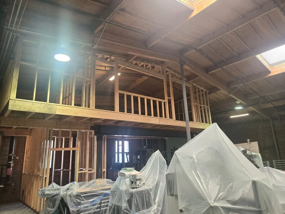 Commercial warehouse timber mezzanine buildout with heavy structural framing by Big City Construction