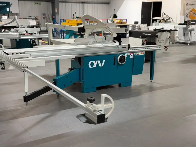 Industrial workshop with various saws and cutting machines on a grey floor.