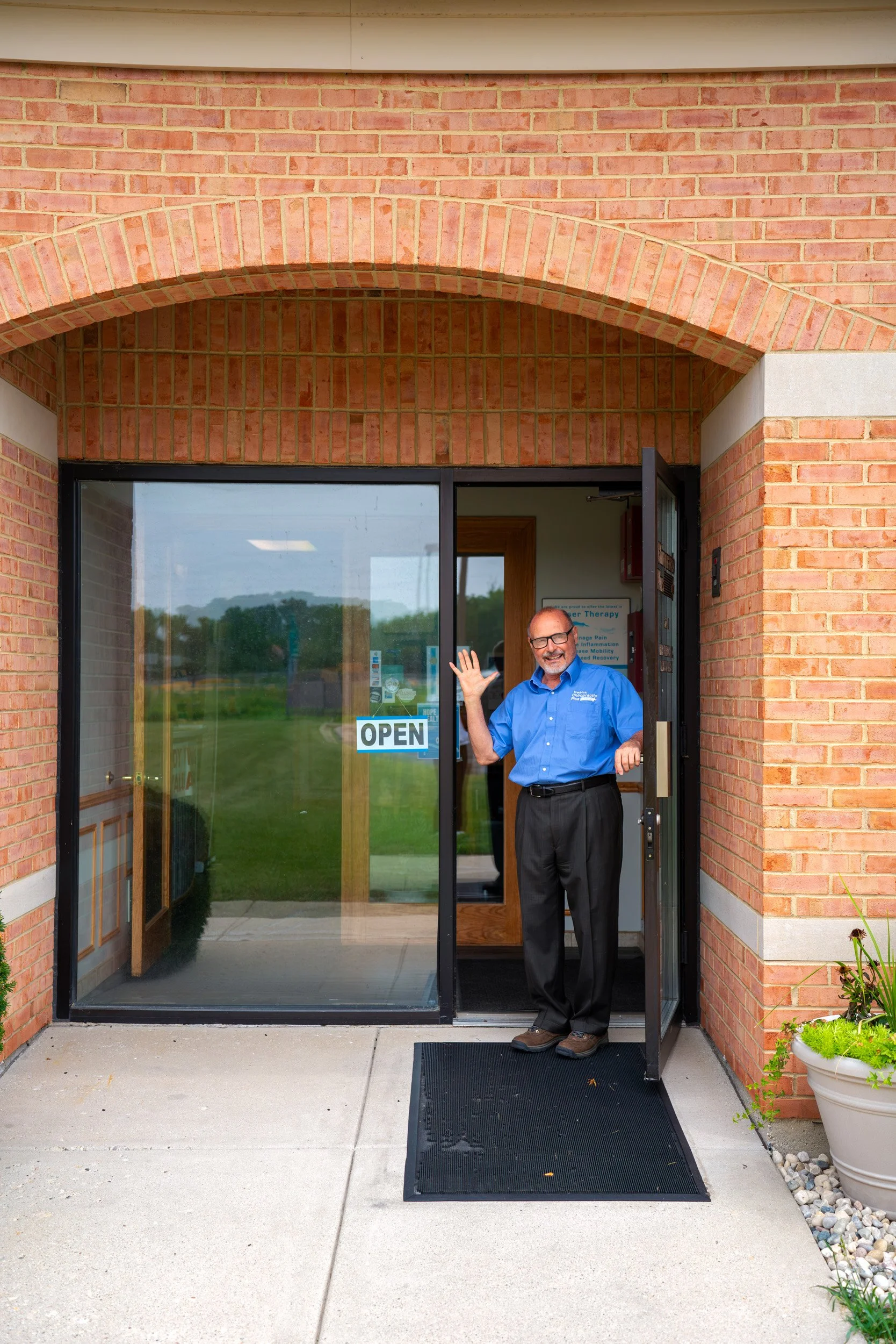 Dr.Fredrick opening the front door, waving.
