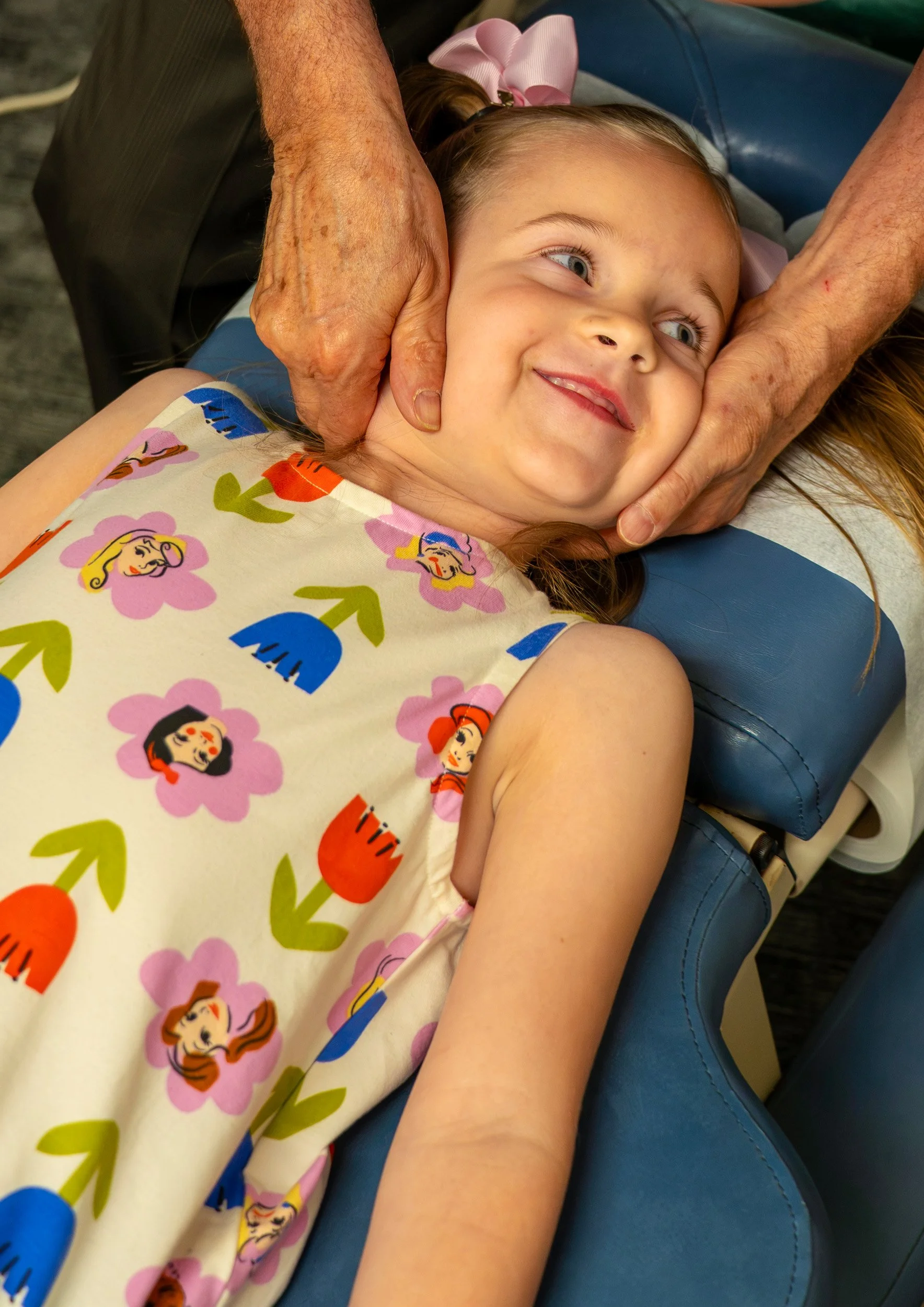 Dr.Fredrick giving a neck adjustment to a child.