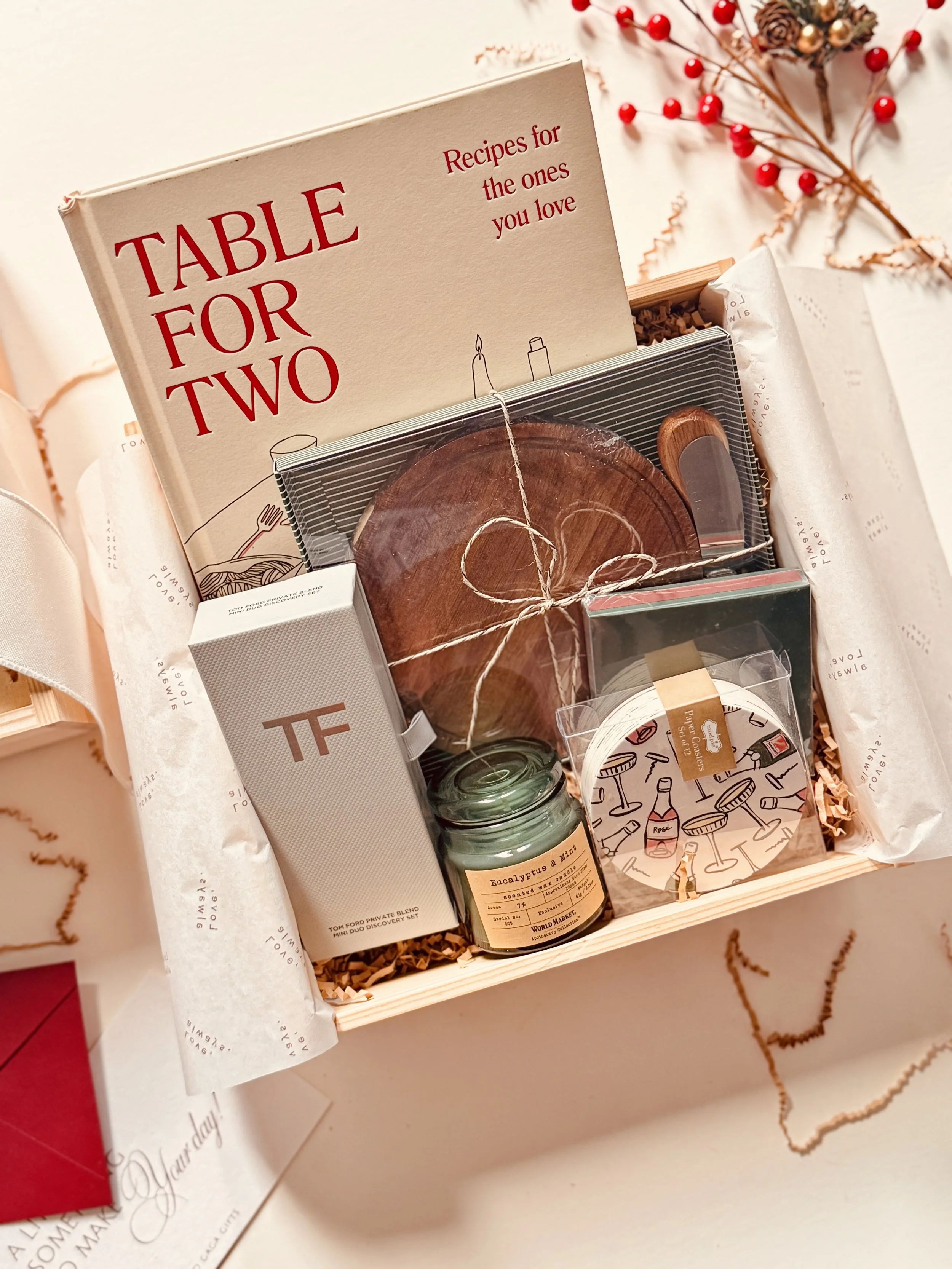 Festive gift box featuring Table for Two cookbook, candle, and coasters