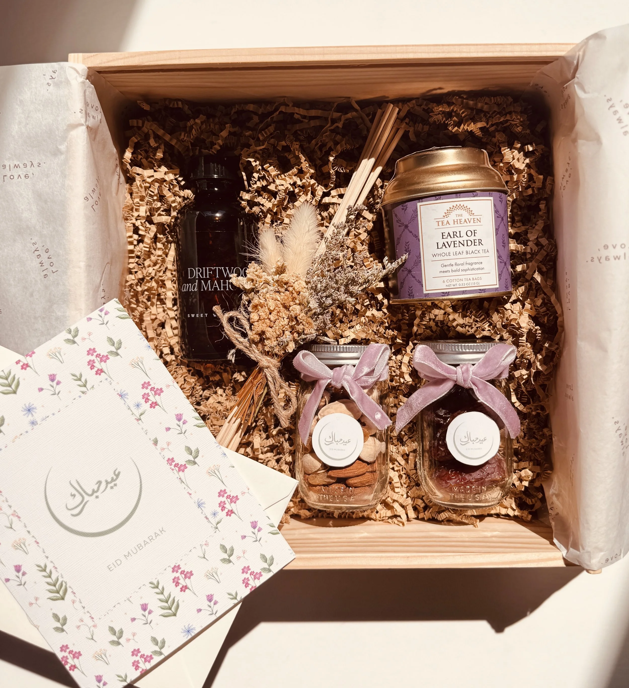 Luxury Eid gift box with tea, dates, dry fruits, and festive keepsakes in elegant packaging