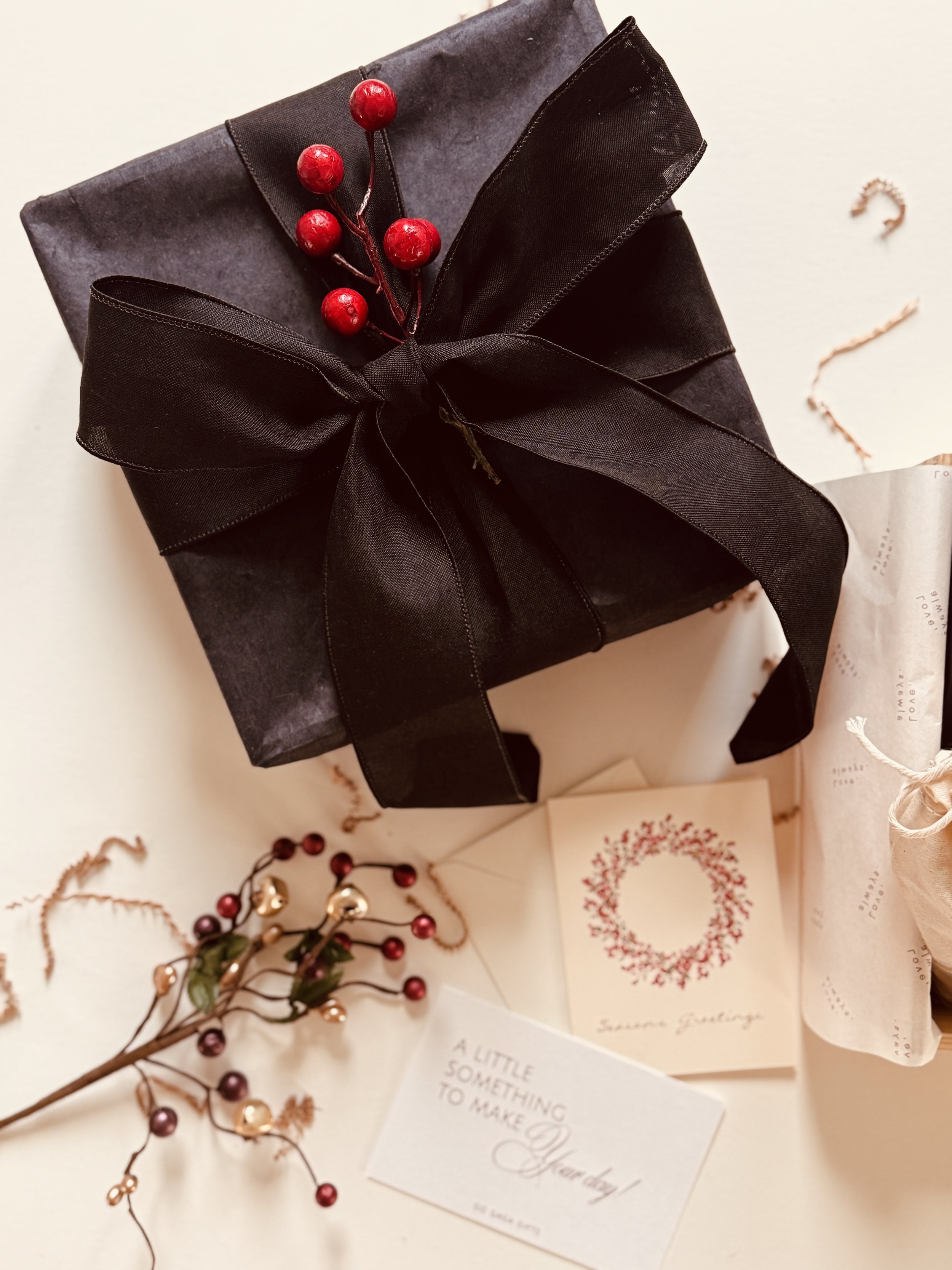 The Midnight Holiday Box, a black-wrapped corporate holiday gift box with berry accents