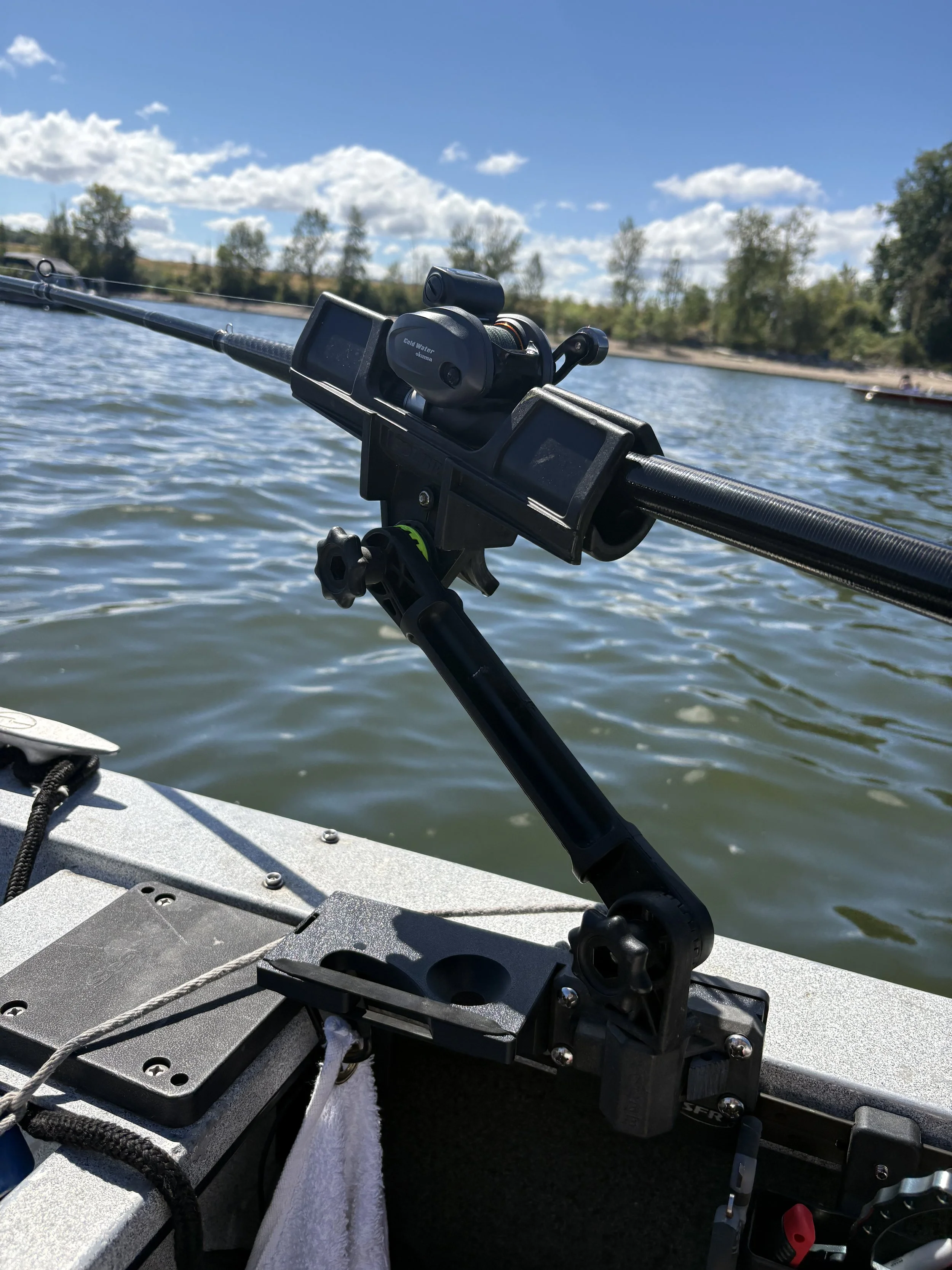 Nook Systems Sidekick securely holding a fishing rod on a fishing boat during a day on the water.