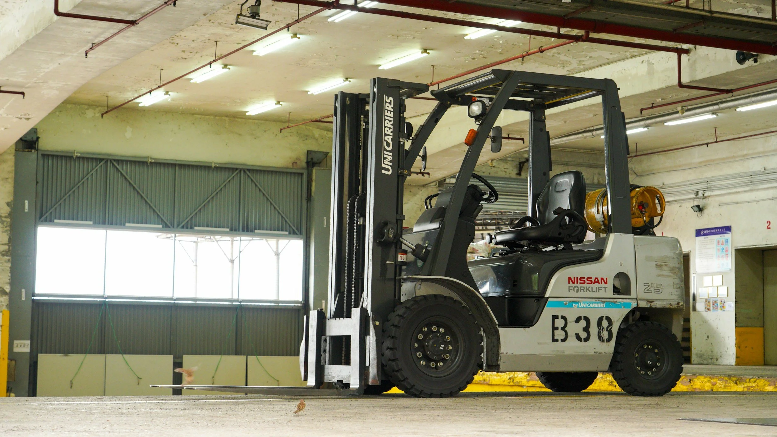A  forklift truck stationary in a warehouse