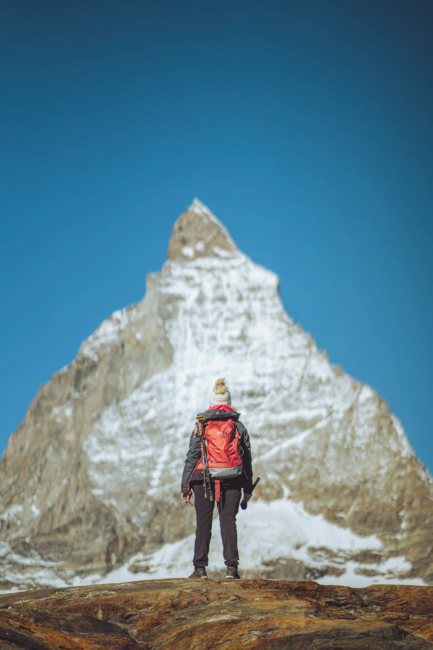 Individual hiking toward a mountain summit, representing personal growth and meaningful change.