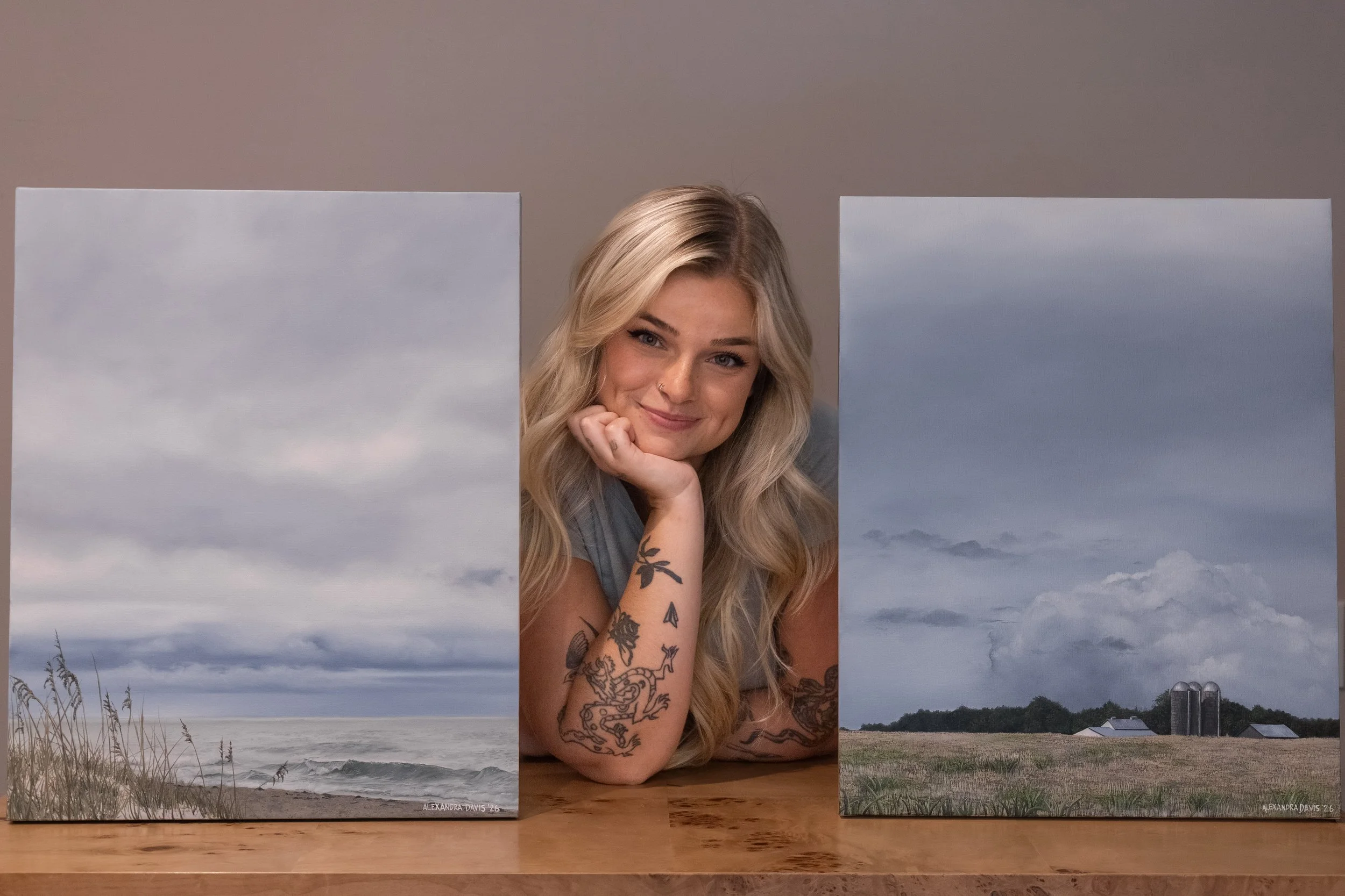 Alex with paintings.JPG