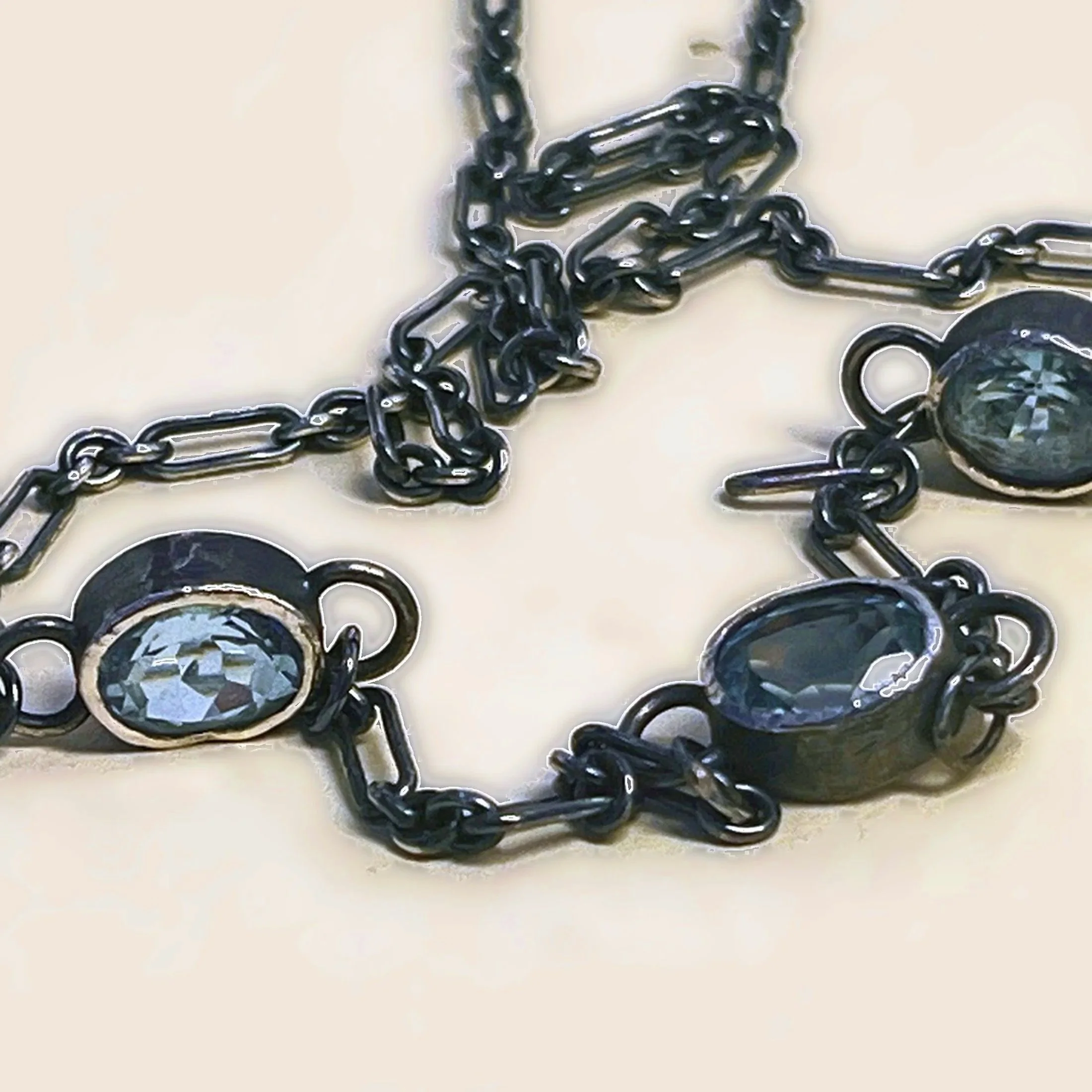 Three-stone necklace — faceted blue topaz on an oxidized sterling silver figaro chain. 
Chain 17.5 in · stones 9x11mm