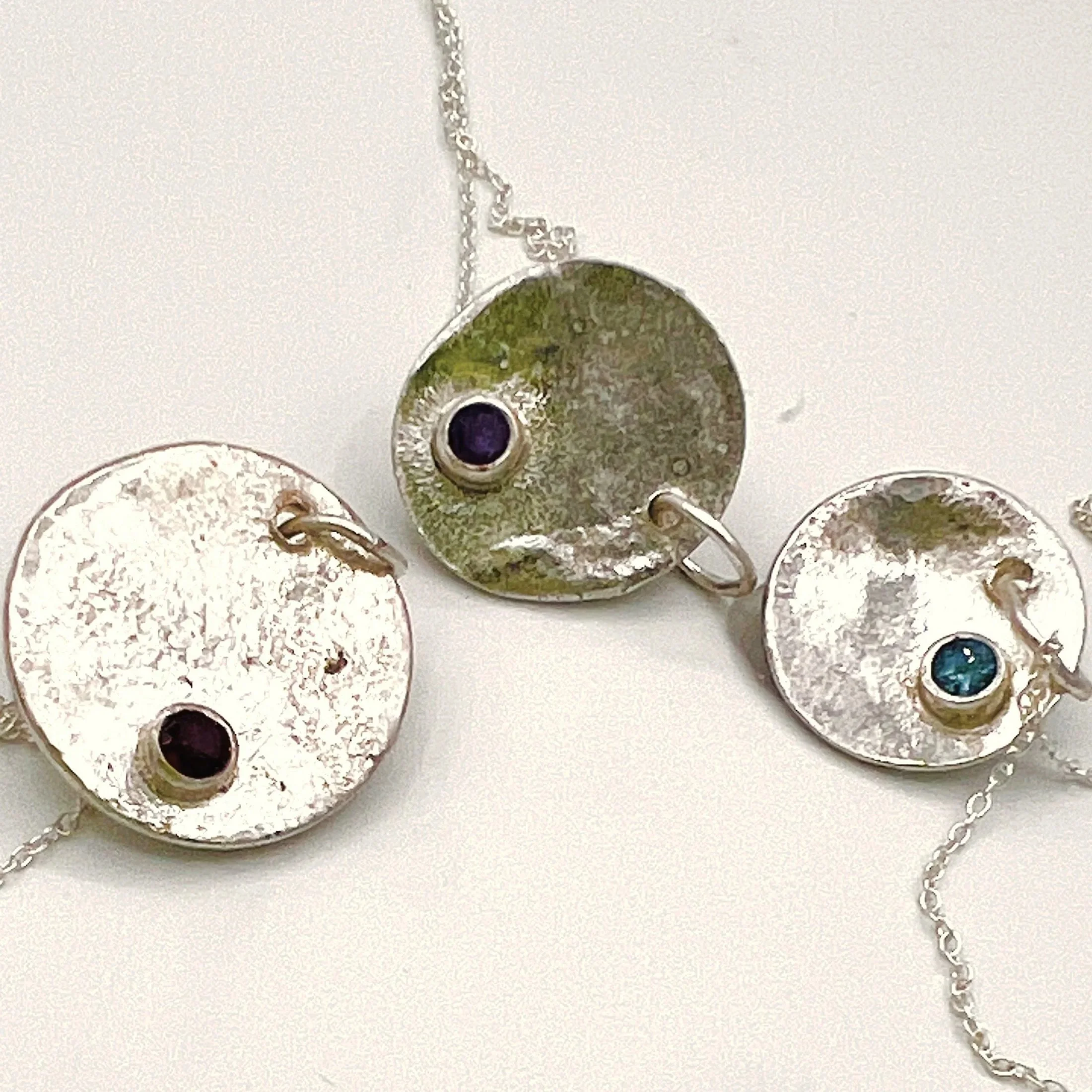 Melted disc pendants — three hand-melted discs, each with a single set  colored stone.
Chain 16in · disc 18x18mm · also made at 15x15mm