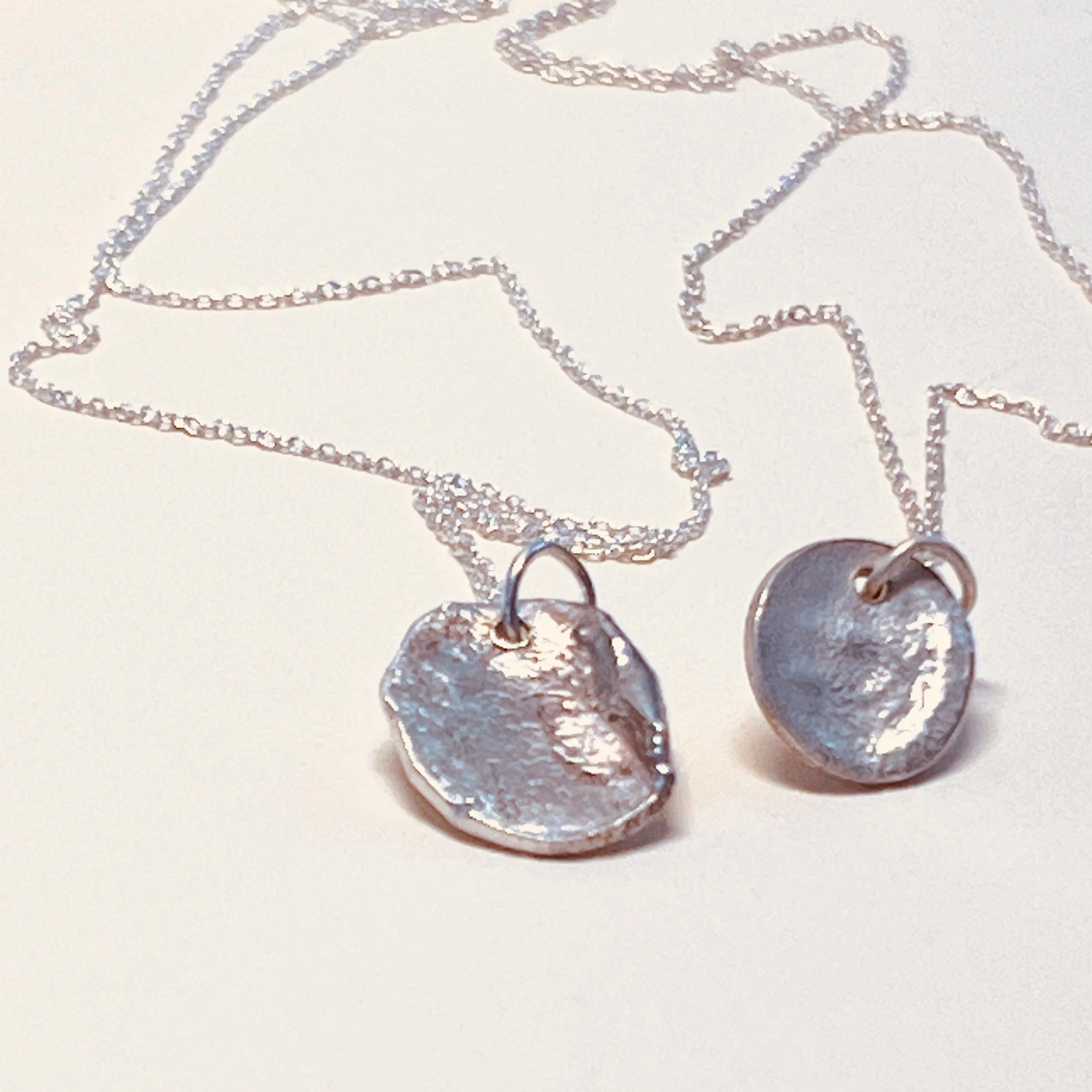 Melted disc pendants — hand-melted sterling silver discs on fine sterling silver chain.
Chain 16in · discs 11x13mm and 13x16mm