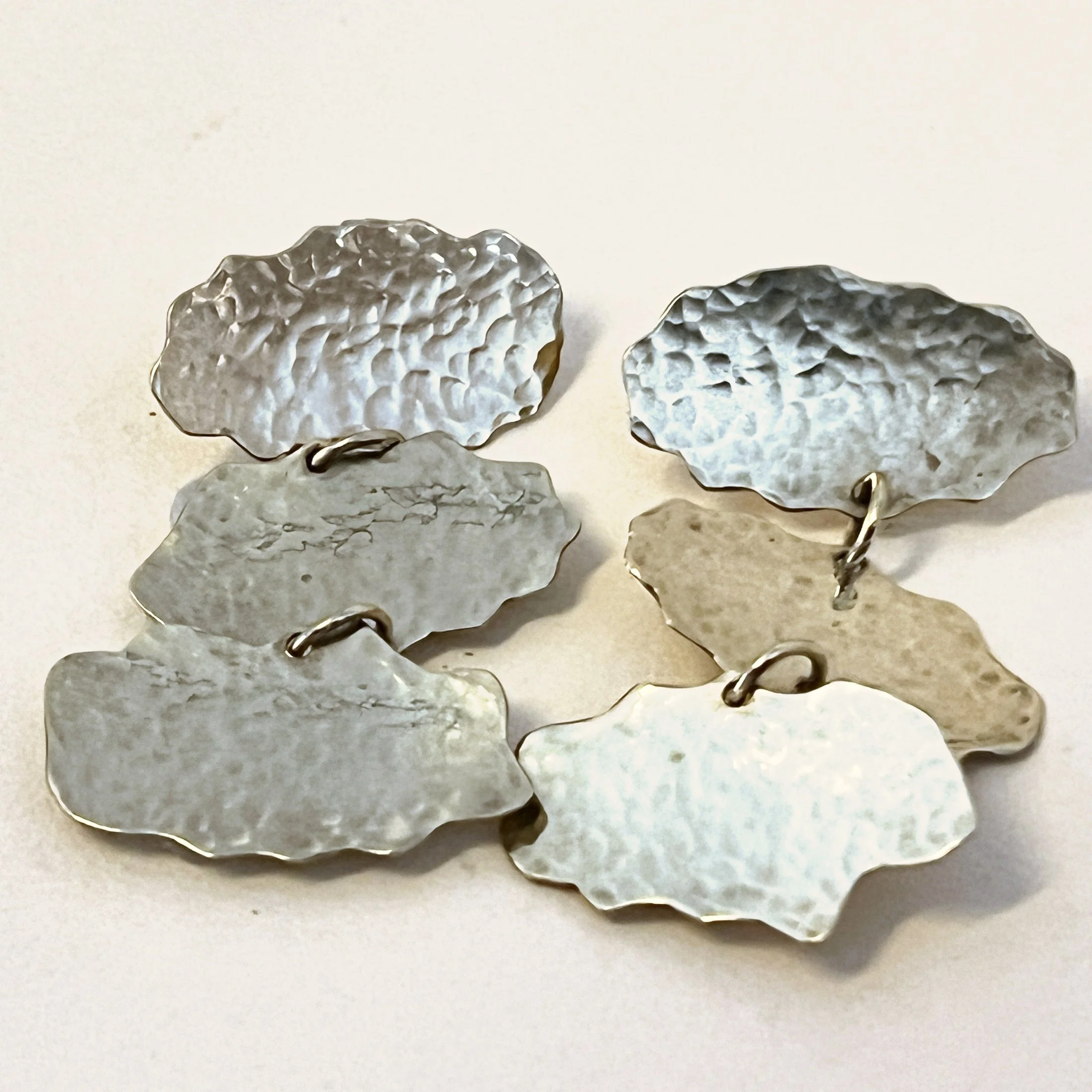Cloud dangler earrings — three hand-cut brass clouds.  
Drop 58mm