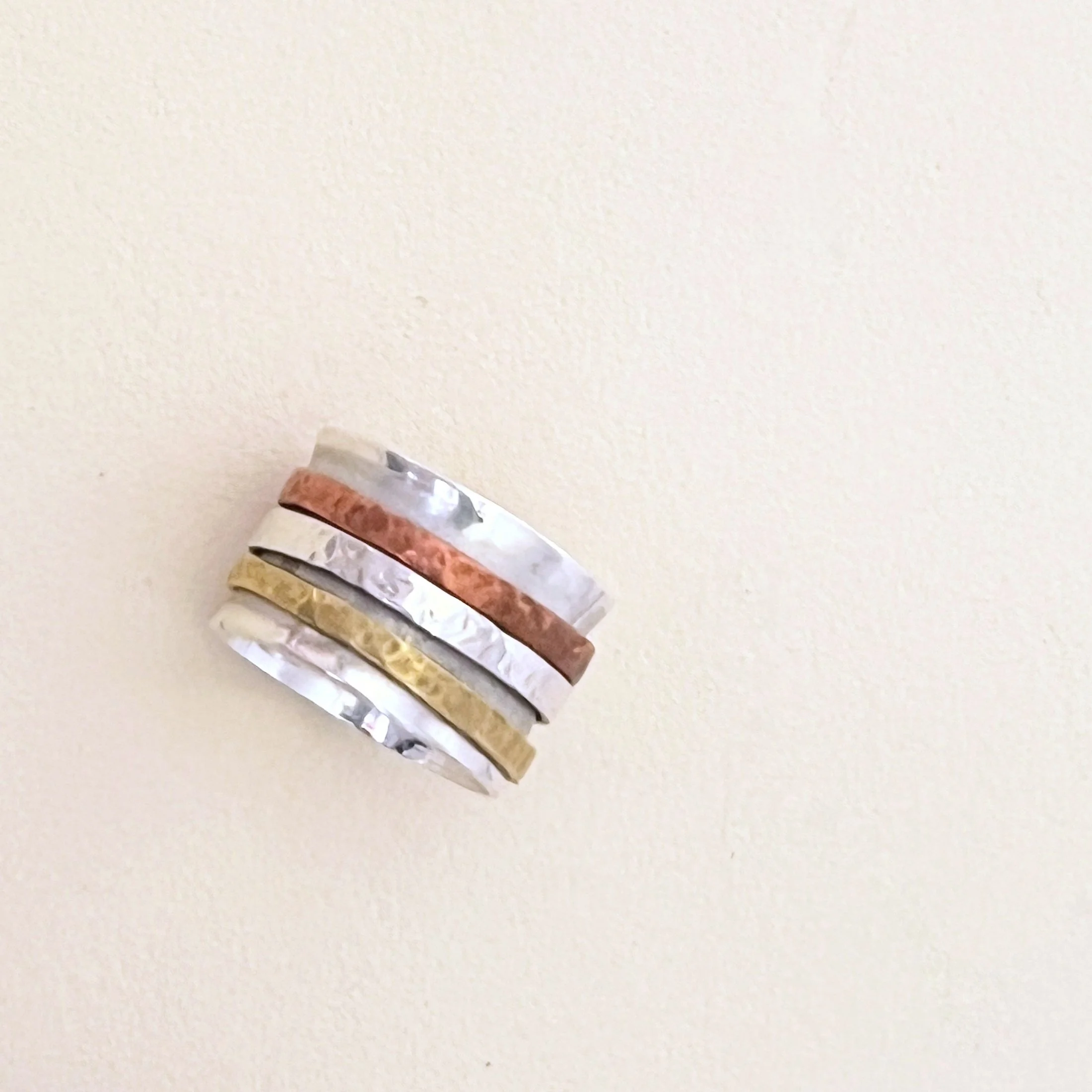 Spinning ring — brass, copper and silver bands set around wide sterling silver band.
Band 8mm · thickness 1mm
