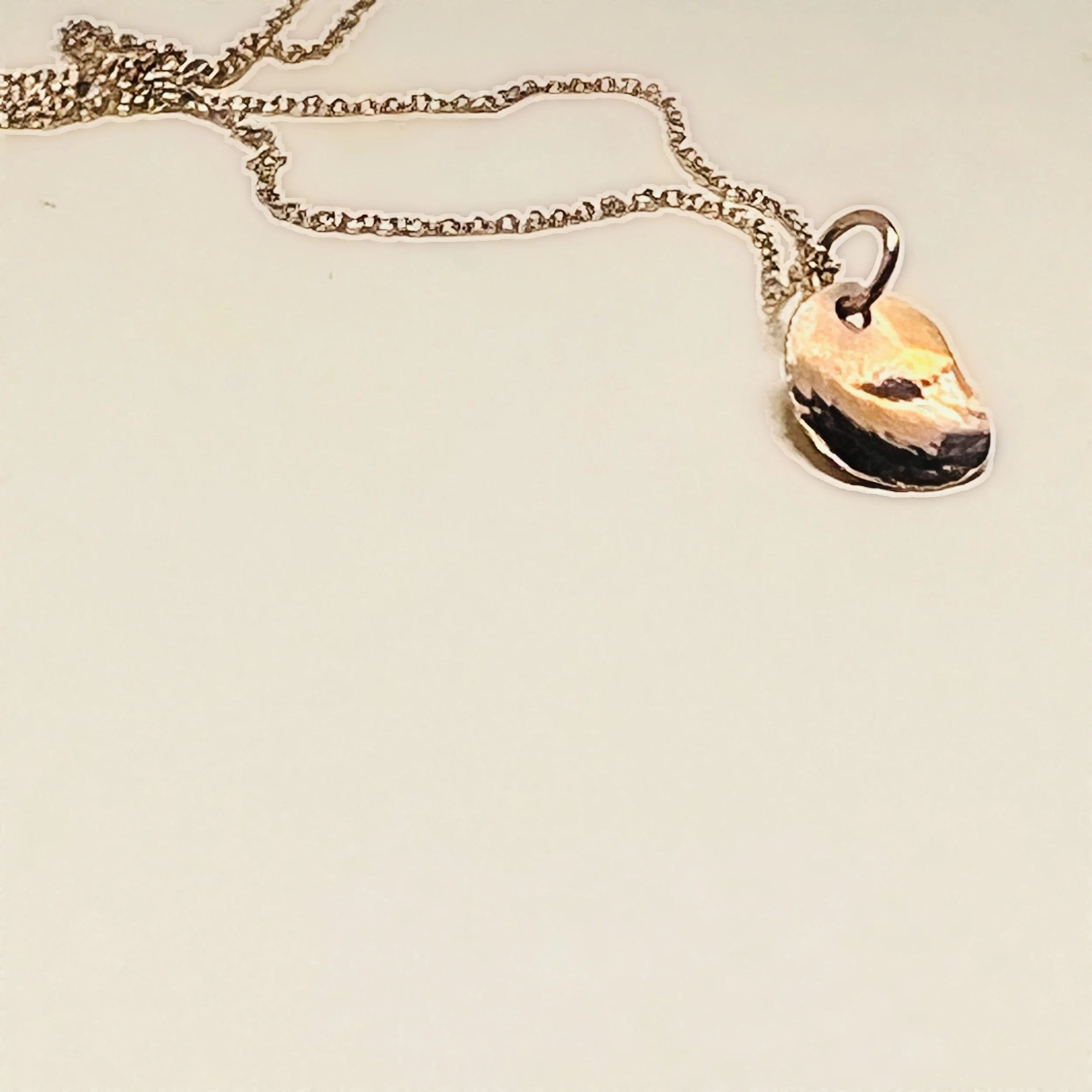 Floating pendant — hammered 14k gold disc on a fine 14k gold filled chain.
Chain 17in · disc 10x12mm