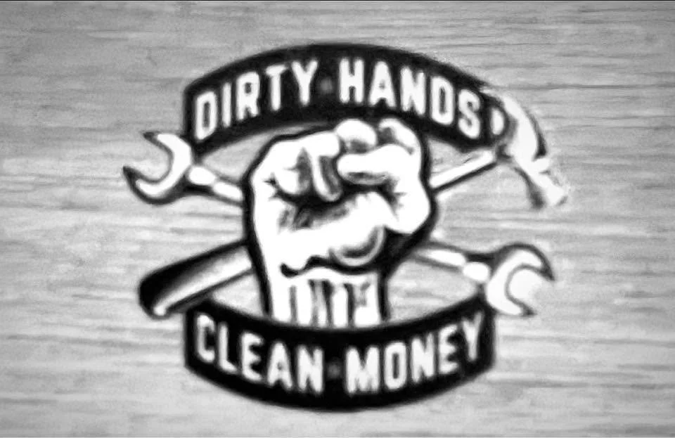 A black and white logo with a clenched fist holding a wrench and screwdriver. The text above the fist reads 'Dirty Hands' and below it 'Clean Money'.