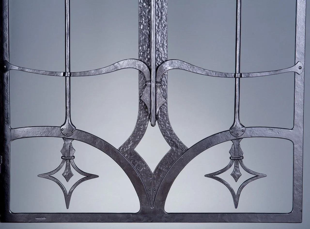 Forged Iron custom front door grille with hand forged joinery